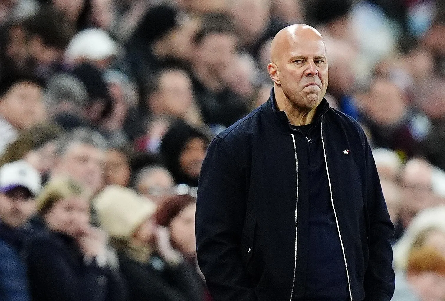 Arne Slot looks dejected on the sidelines