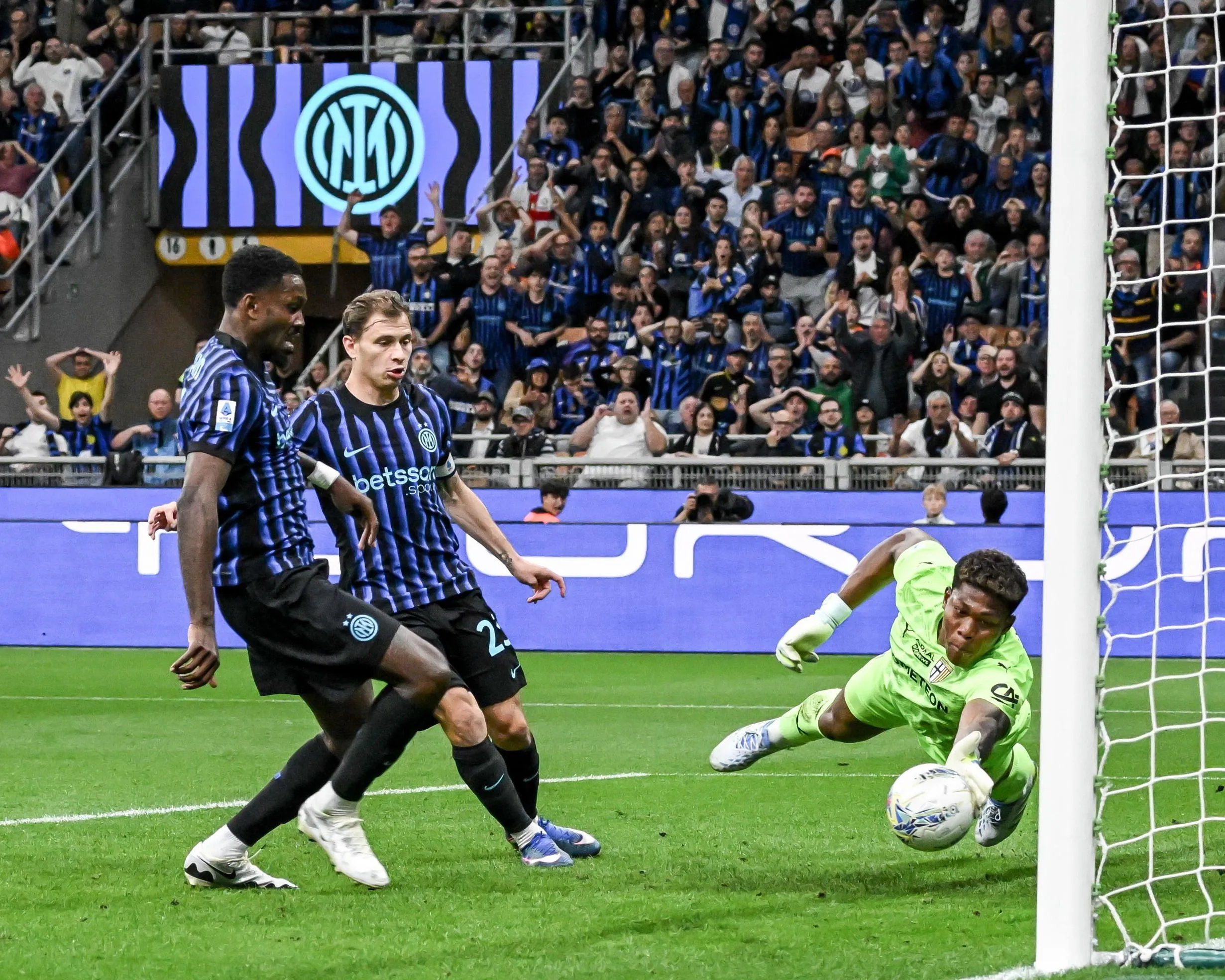 Parma’s Zion Suzuki (right) makes a remarkable save to deny Marcus Thuram (left)