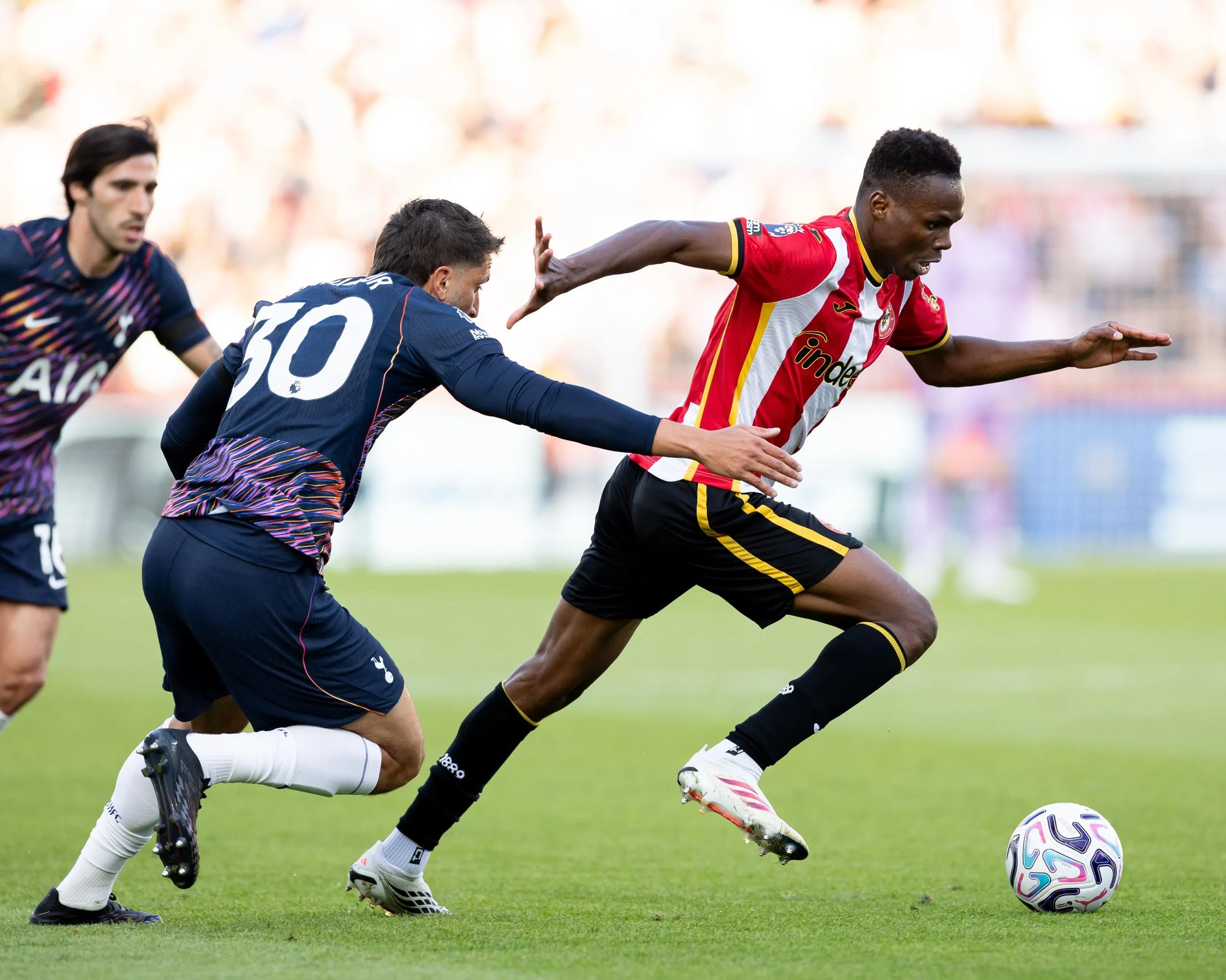 The Brentford midfielder Mamadou Sangaré (right) runs past the Tottenham midfielder Sandro Tonali (left) during his team’s 3-0 Premier League home win.