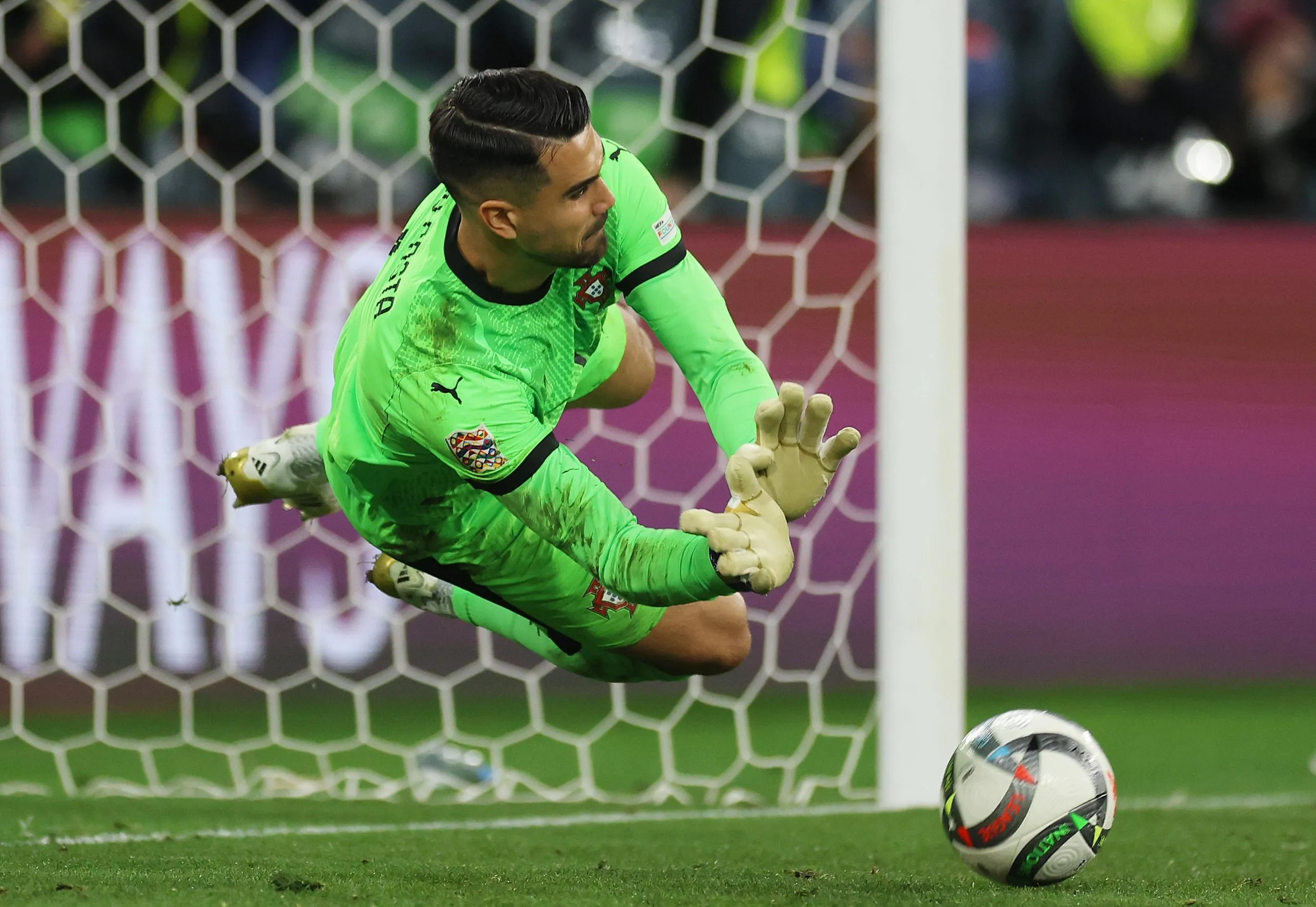 Diogo Costa of Portugal saves a penalty taken by Alvaro Morata of Spain.