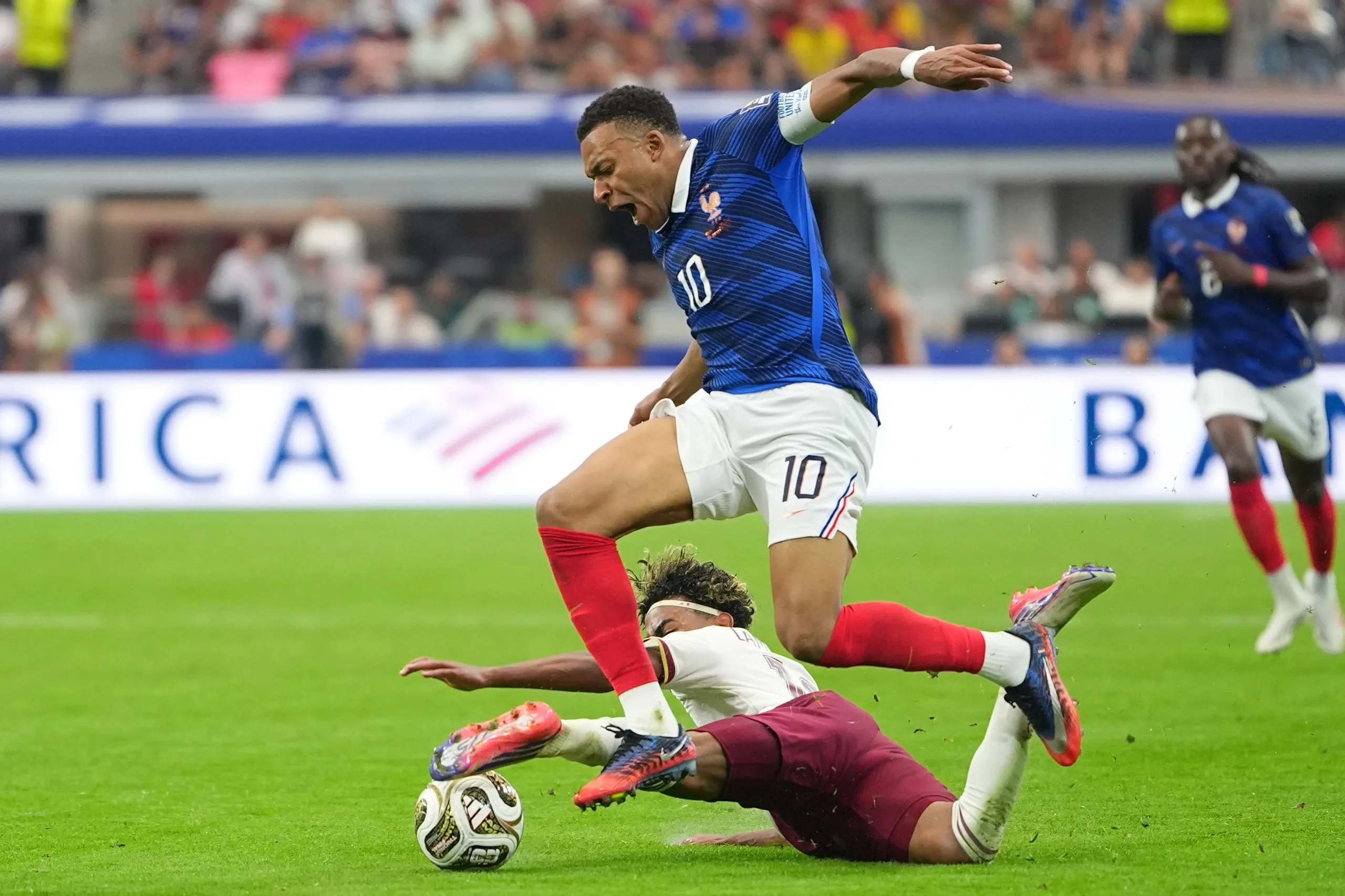 Spain's Lamine Yamal, left, brings down France's Kylian Mbappe.