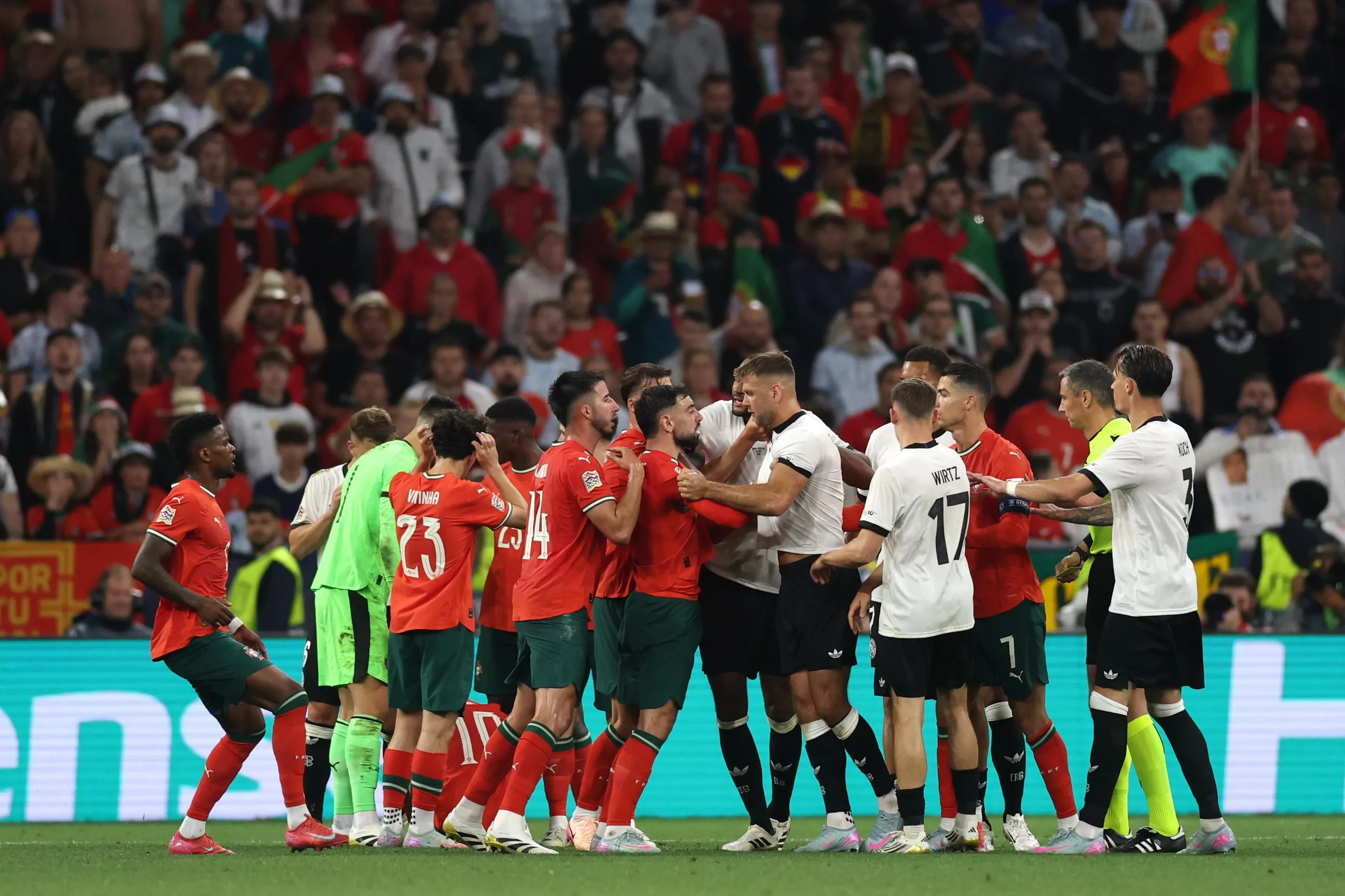 Niclas Fullkrug of Germany clashes with Bruno Fernandes of Portugal.