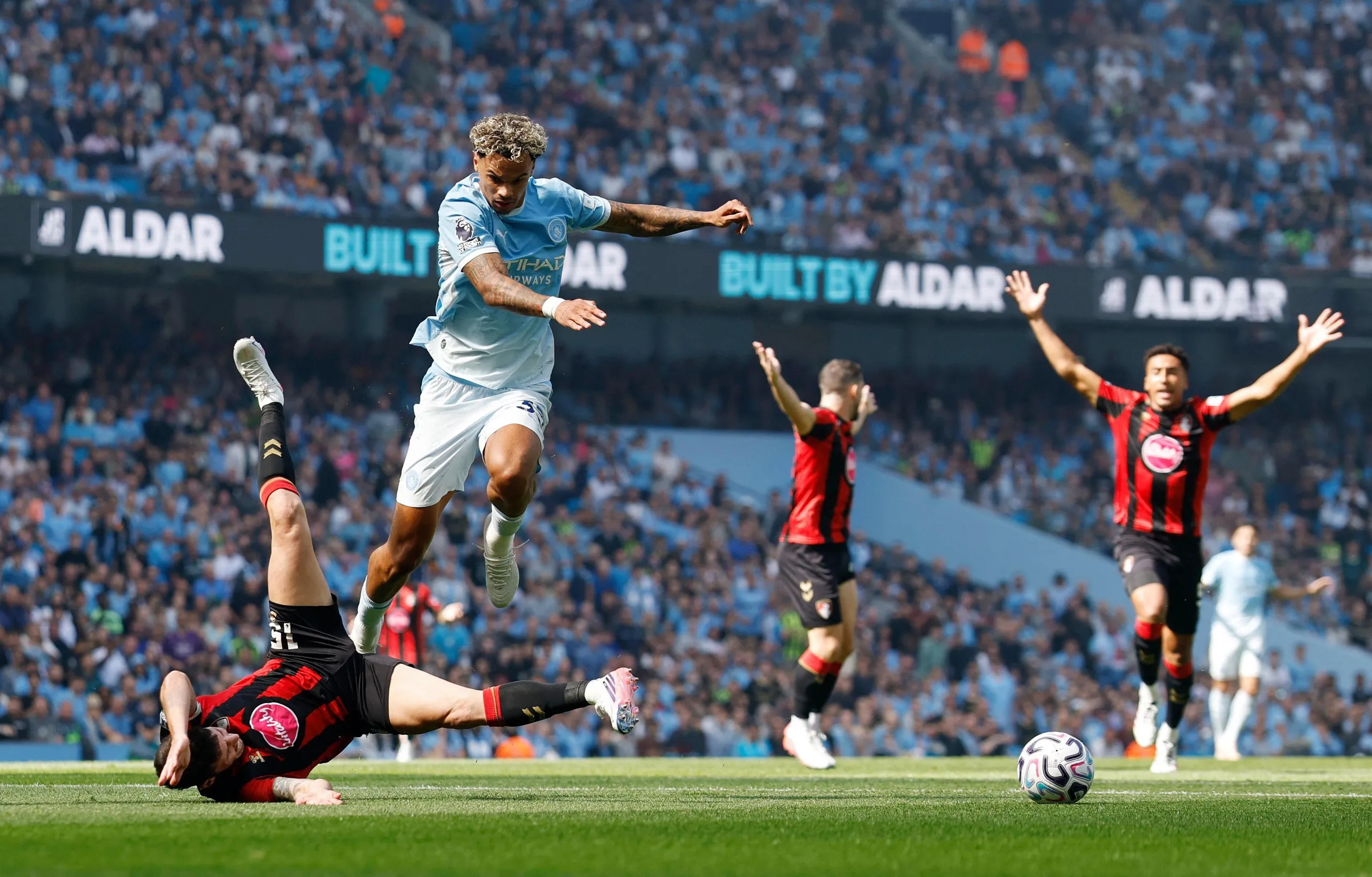 Manchester City's Nico O'Reilly in action with AFC Bournemouth's Adam Smith.