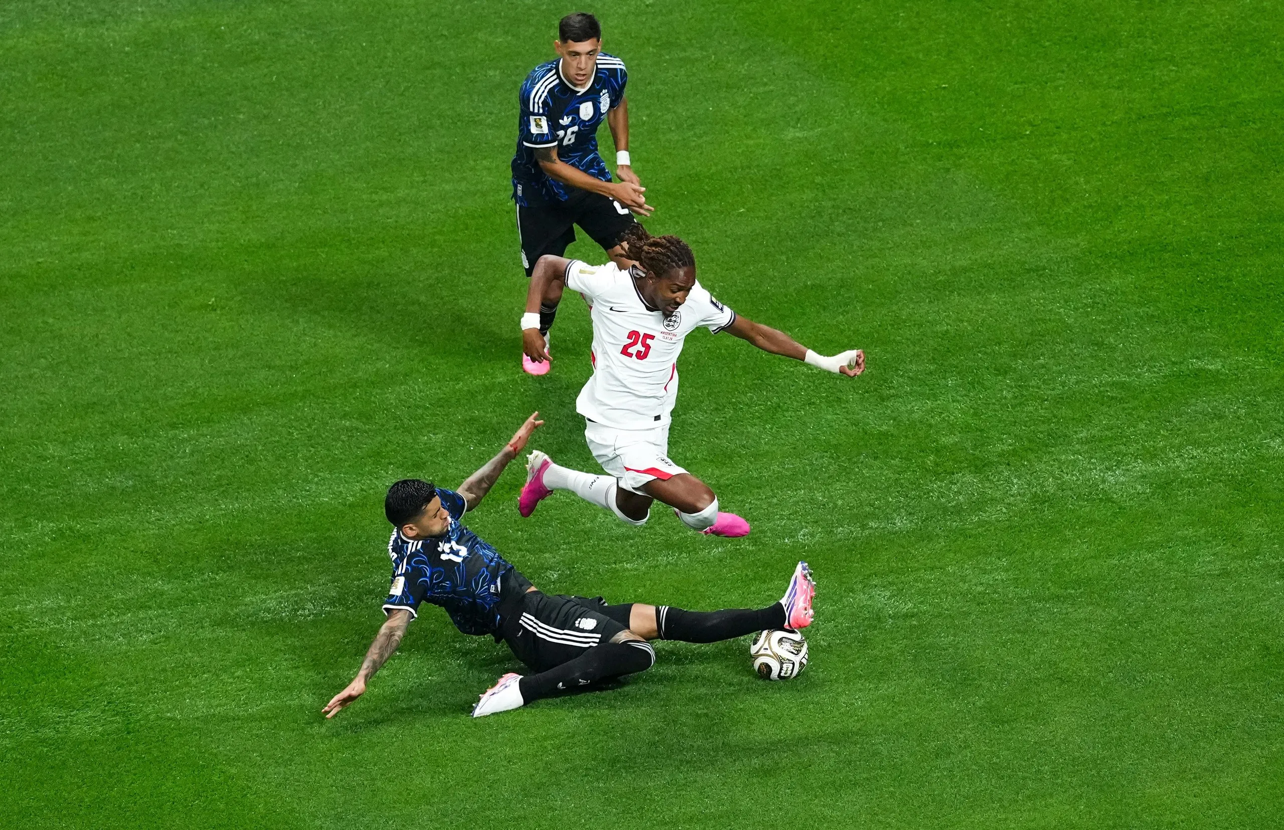 Djed Spence jumps over an Argentina player during England’s match in the World Cup
