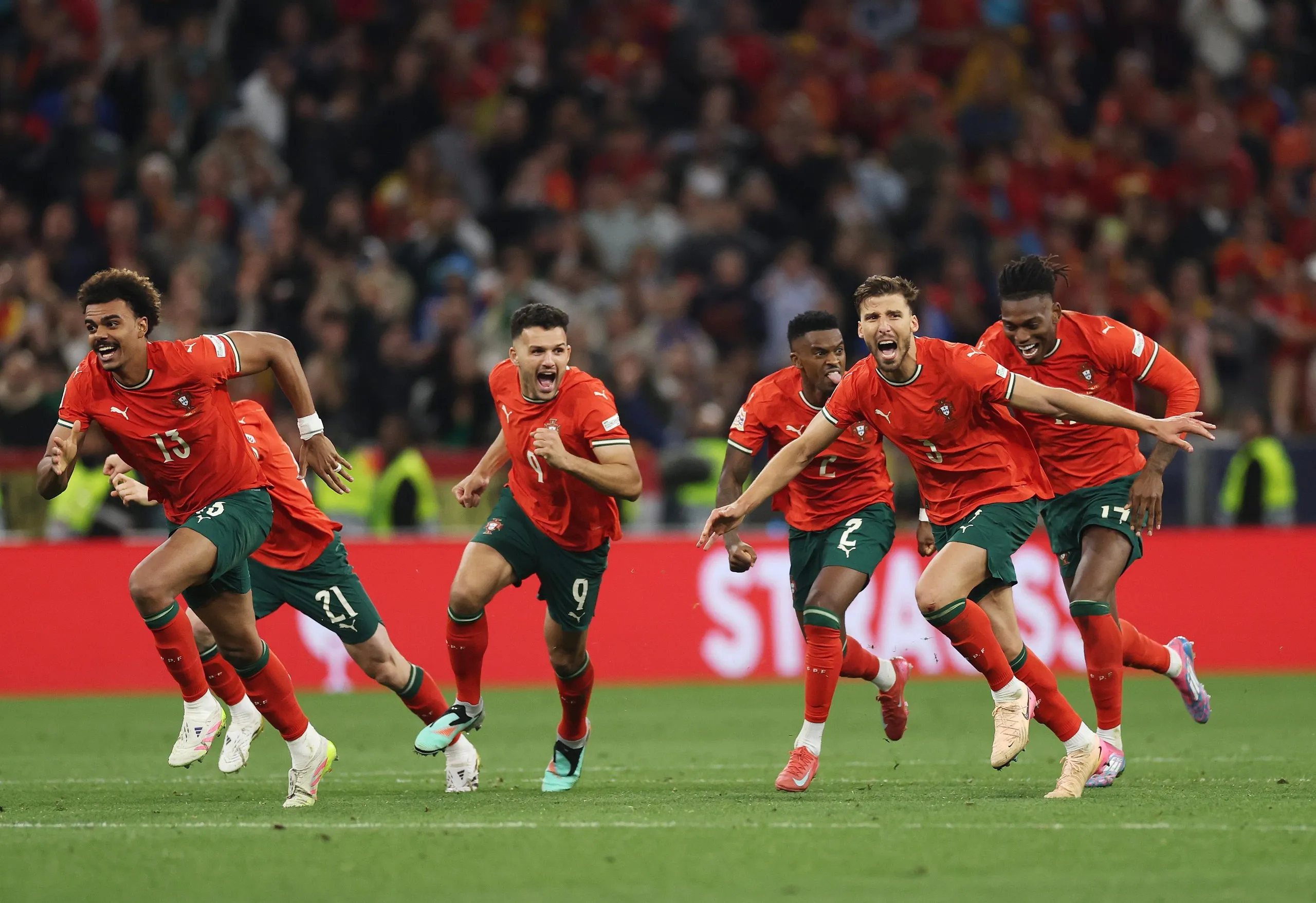Ruben Dias and team-mates of Portugal celebrate after Ruben Neves scores the winning pen.