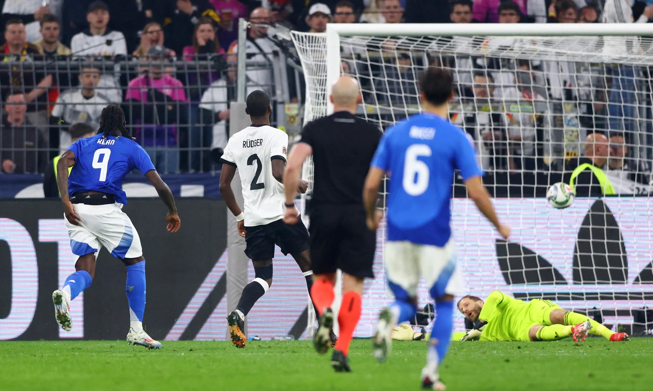 Italy's Moise Kean scores their first goal past Germany's Oliver Baumann.