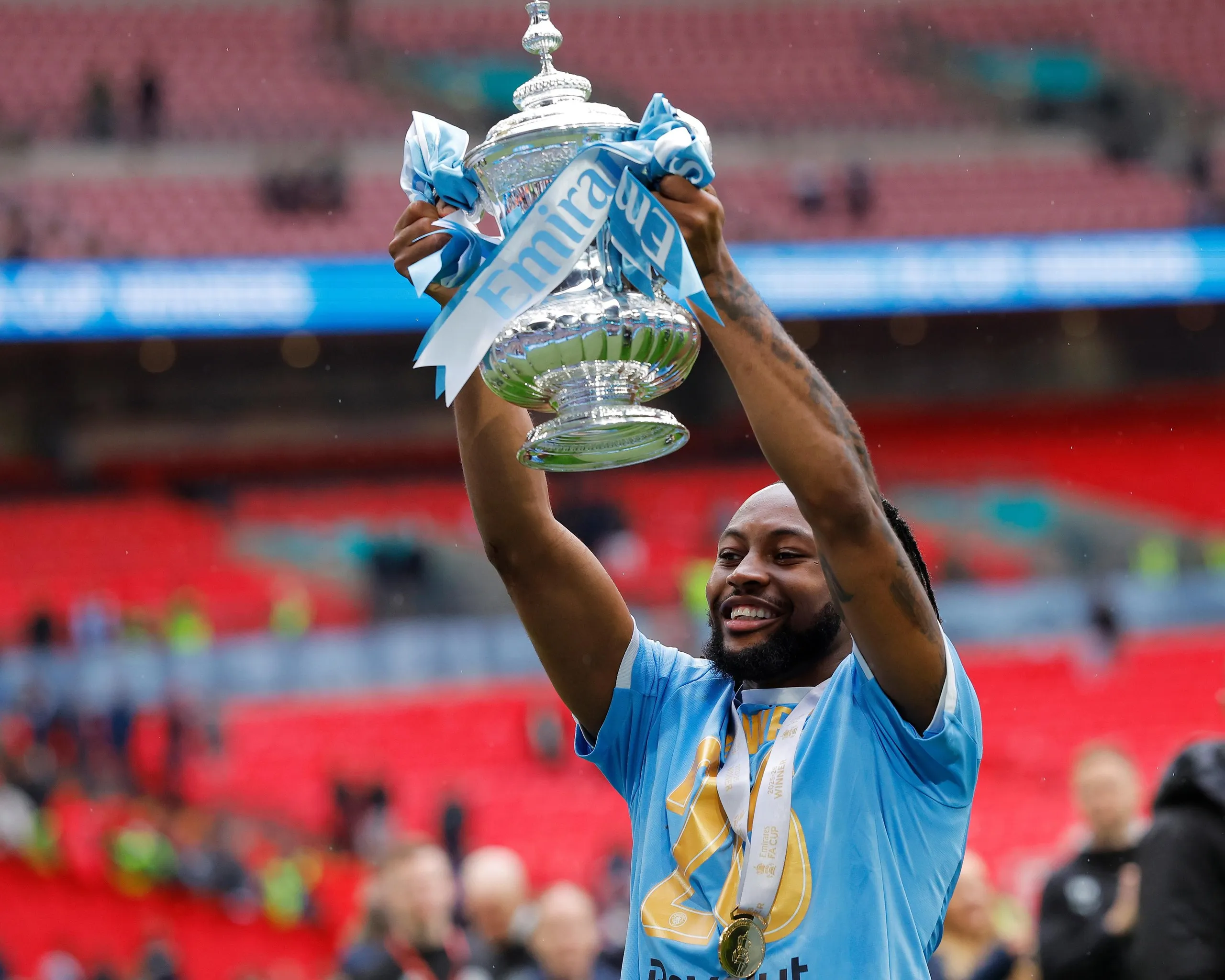 Antoine Semenyo of Manchester City celebrates with the FA Cup trophy.