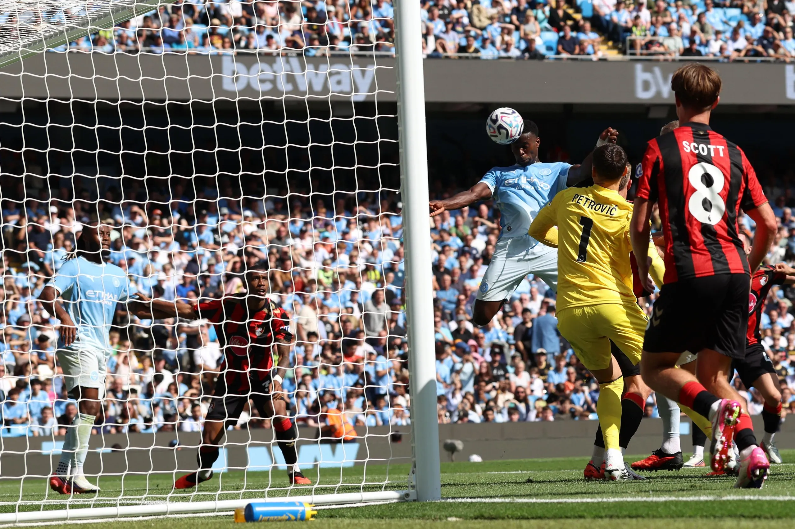 Manchester City's English defender Marc Guehi (C) misses the target.