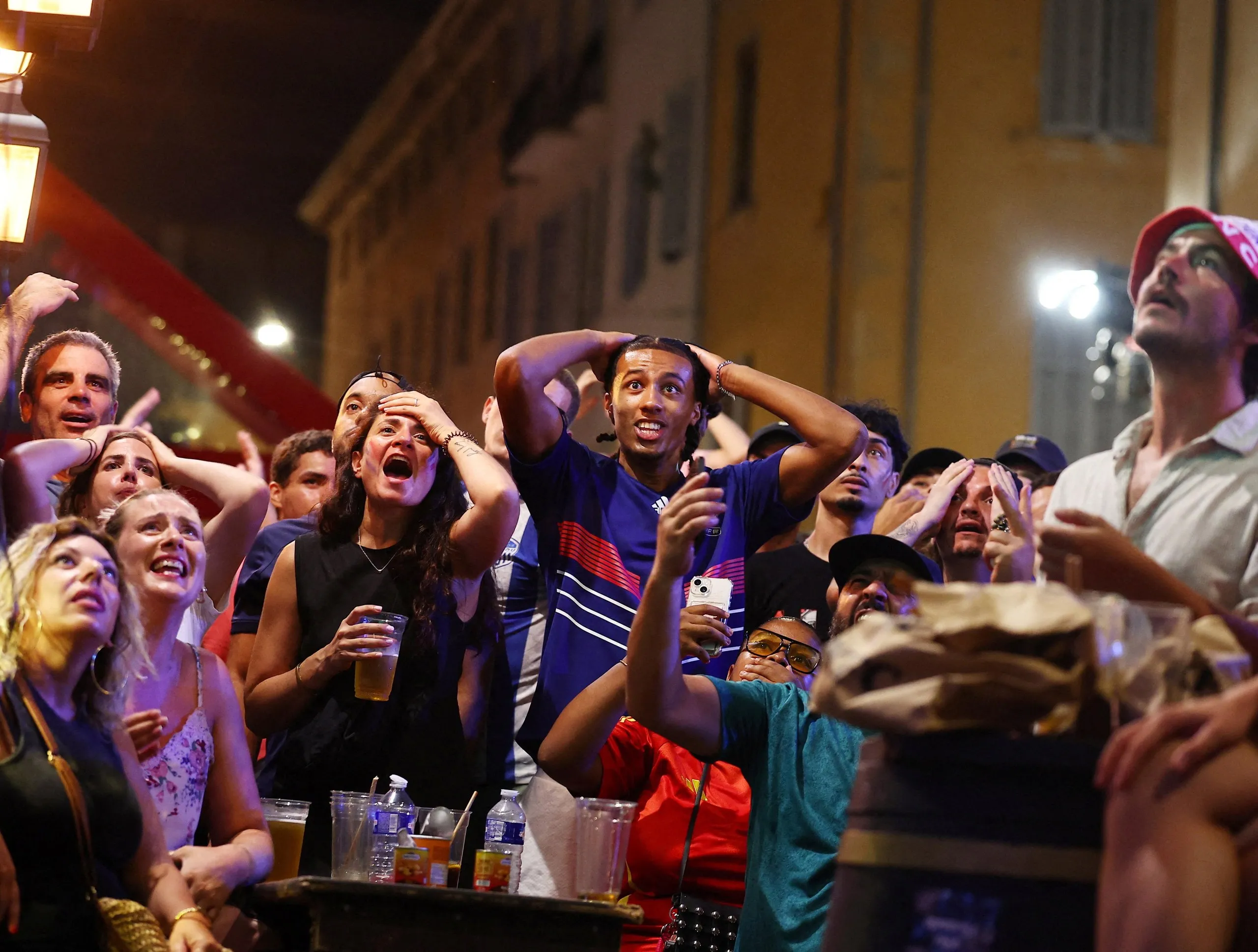 France fans show their dismay as they watch the World Cup semi-final match between France and Spain
