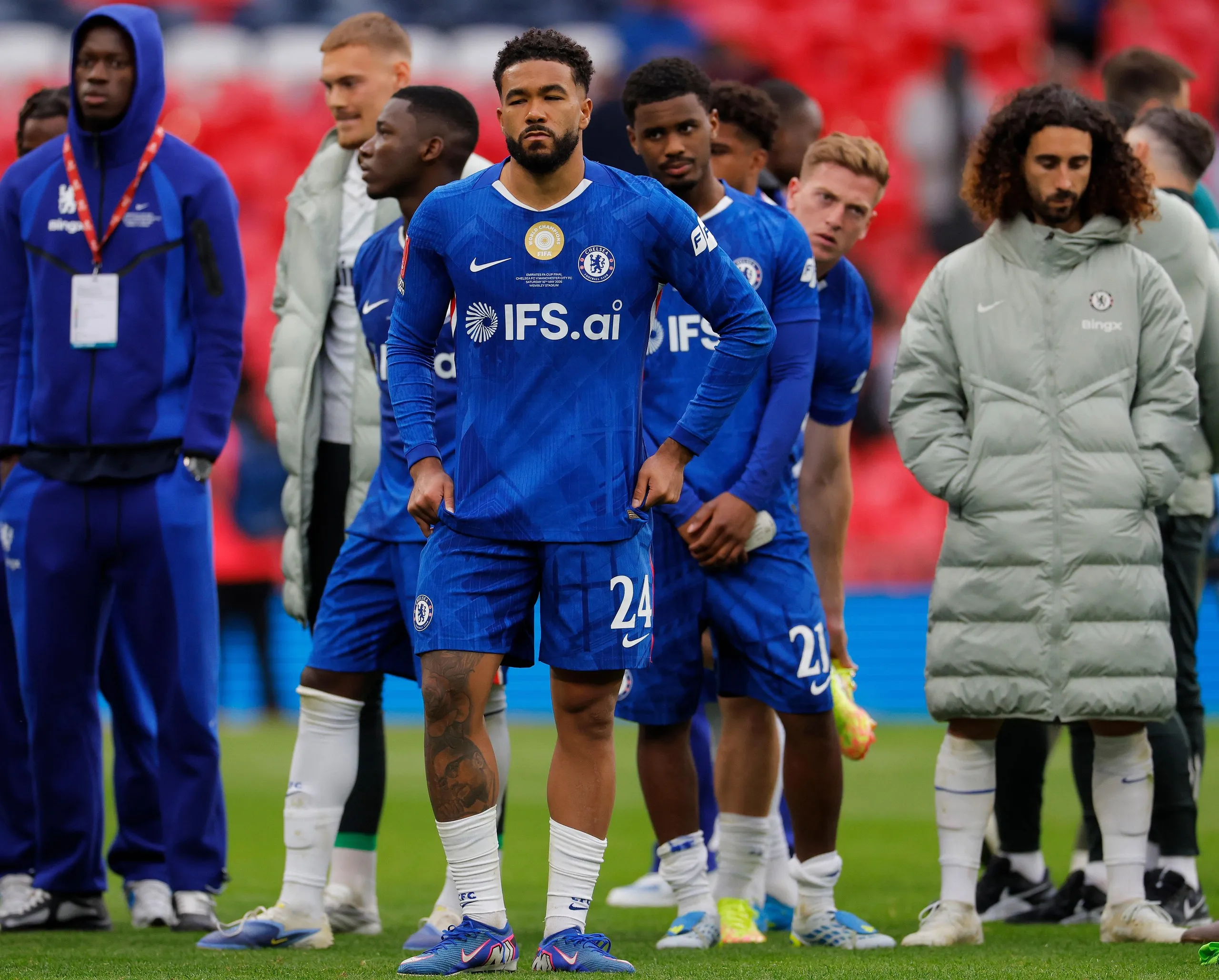 Reece James (centre) and his Chelsea teammates look dejected after their defeat.