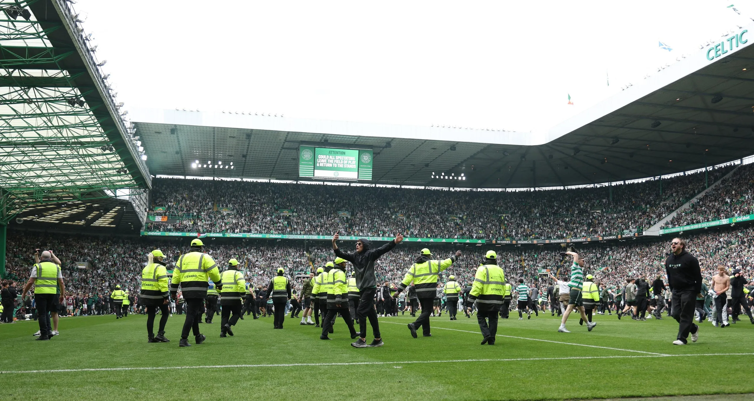 Celtic fans invade the pitch after Callum Osmand’s goal