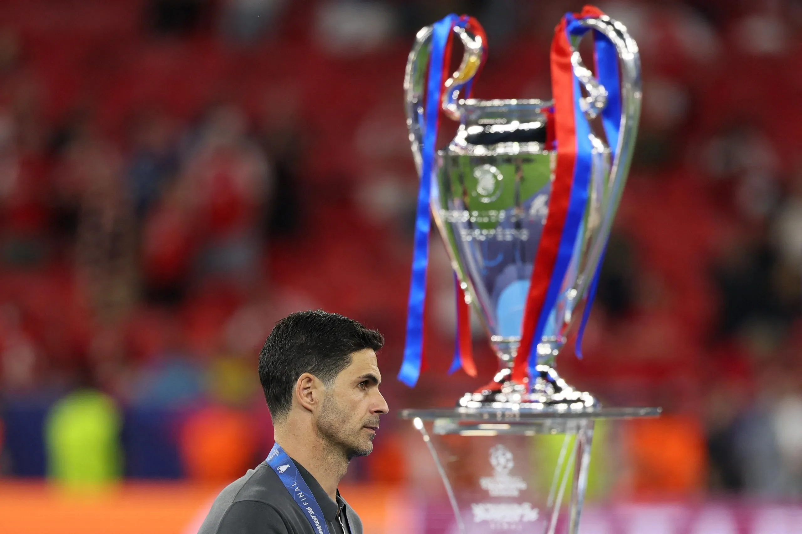 Mikel Arteta walks past the Champions League trophy in Budapest