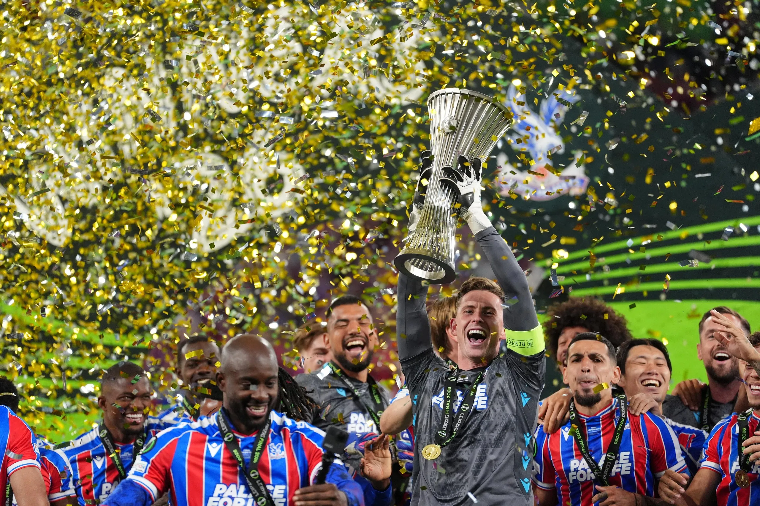 Crystal Palace goalkeeper Dean Henderson lifts the trophy with team-mates after victory over Rayo Vallecano in the UEFA Europa Conference League final.