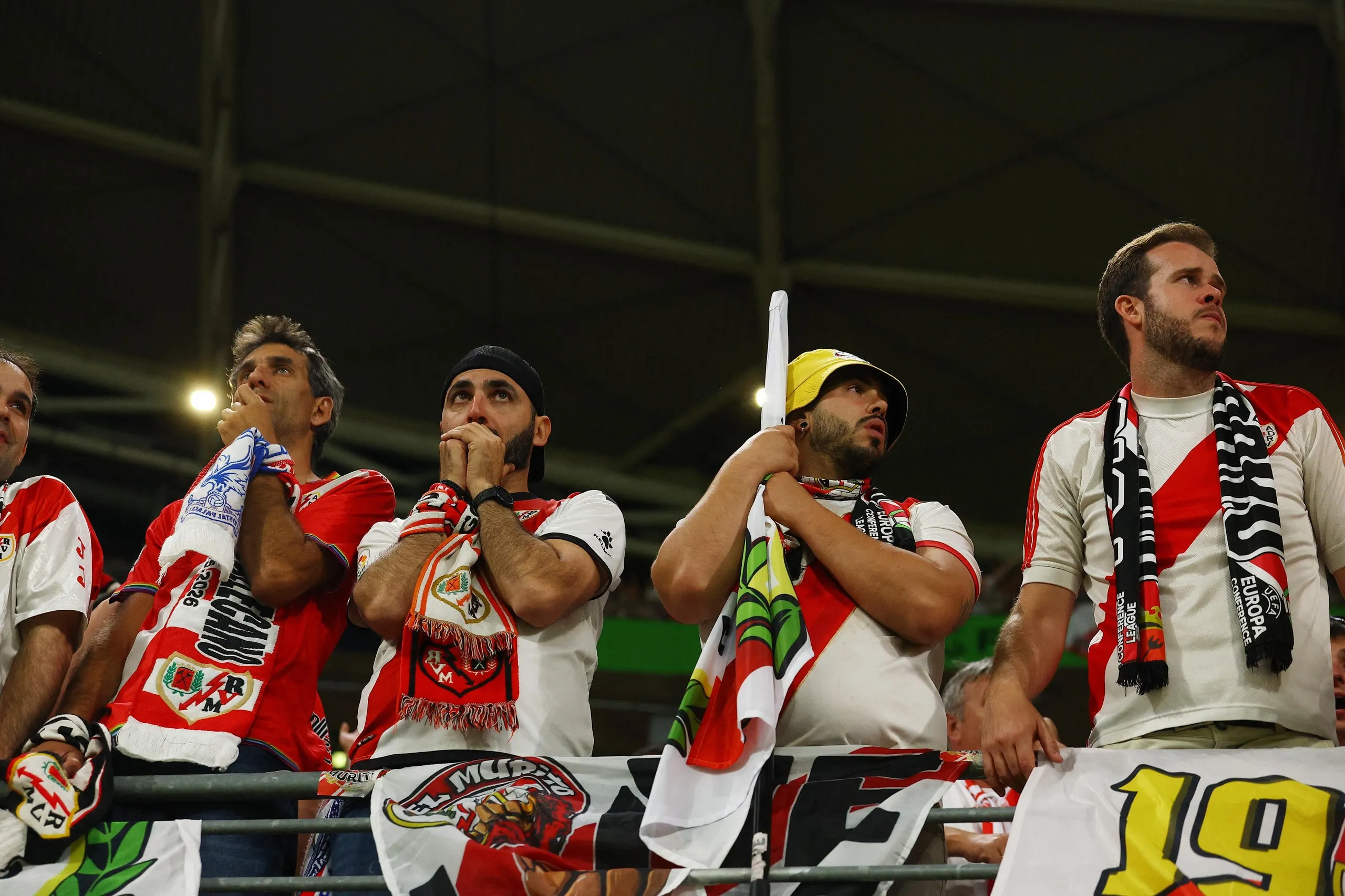Rayo Vallecano fans look dejected in the stands.