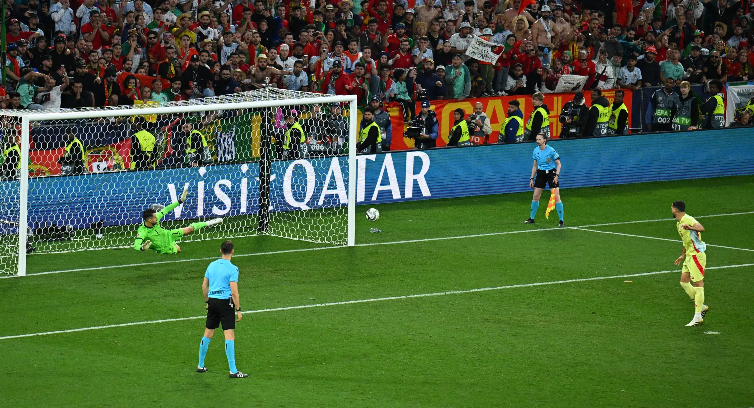 Spain's Mikel Merino scores a penalty during the shoot-out past Portugal's Diogo Costa.