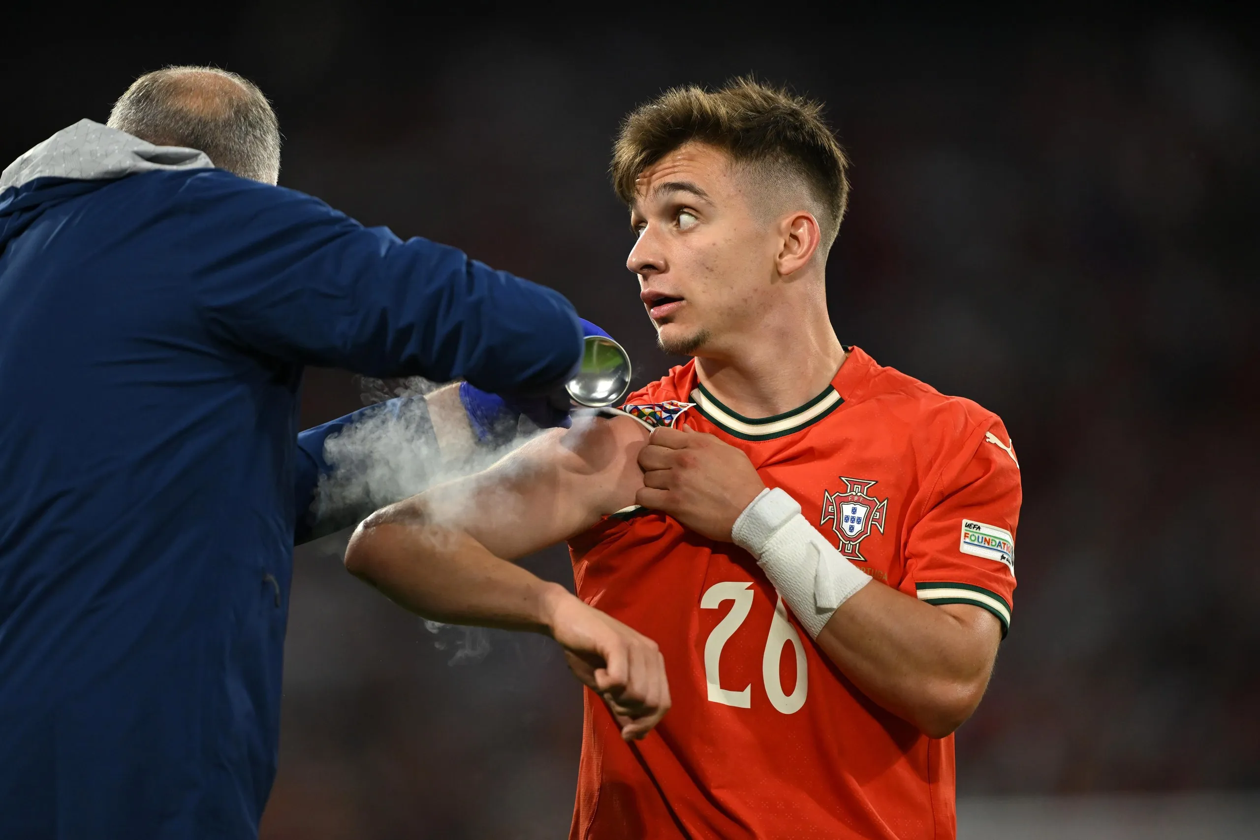 Francisco Conceicao of Portugal is treated by medical staff during the Nations League semi-final against Germany.
