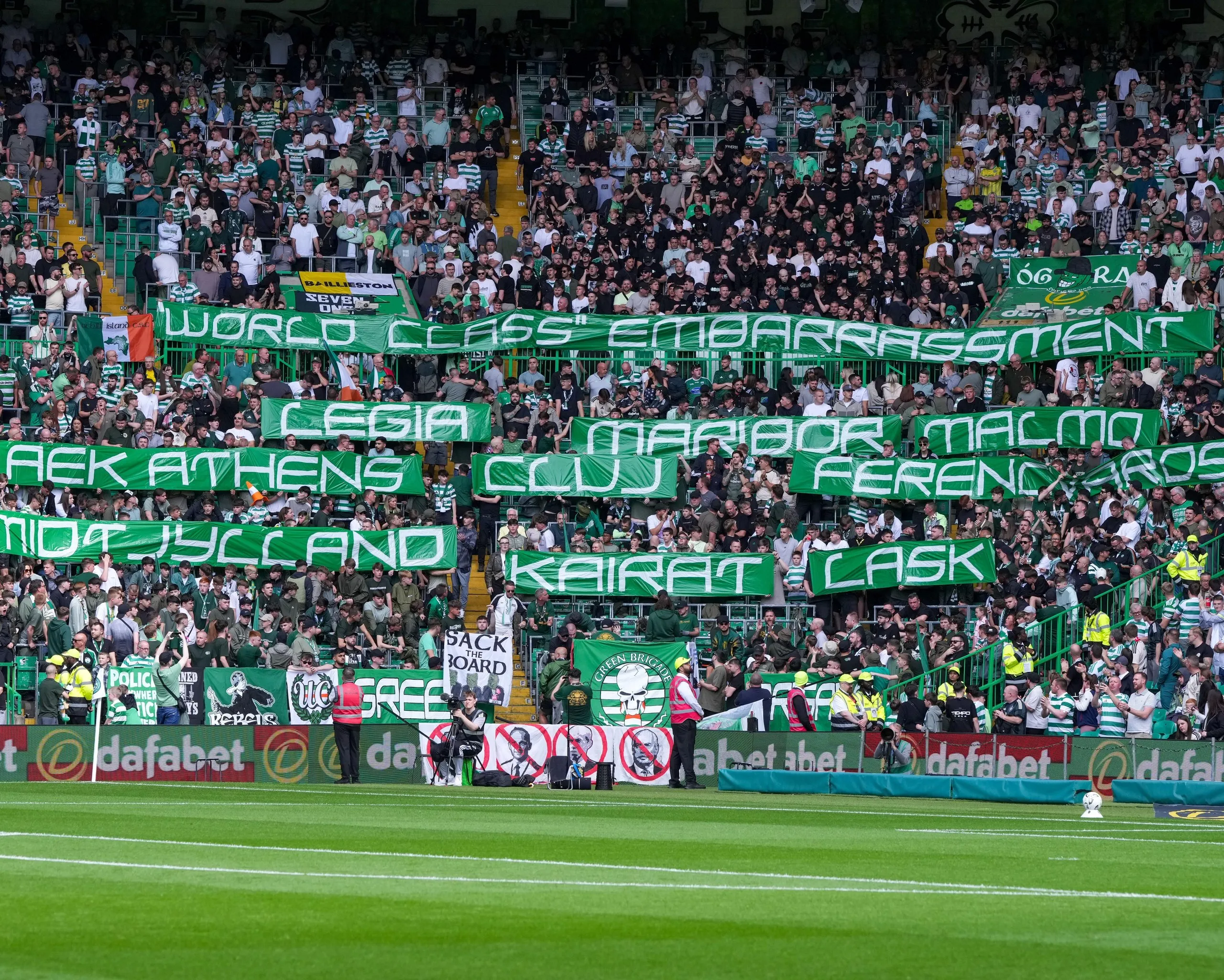 Fans hold up banners with the names of teams that have eliminated Celtic from Europe.