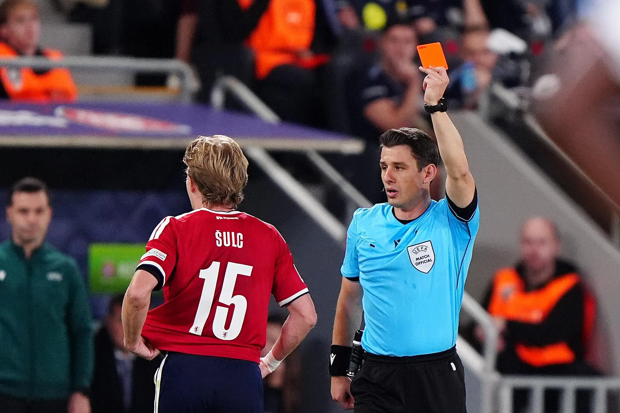 Pavel Sulc is shown a red card by Halil Meler for a foul on Elliot Anderson.