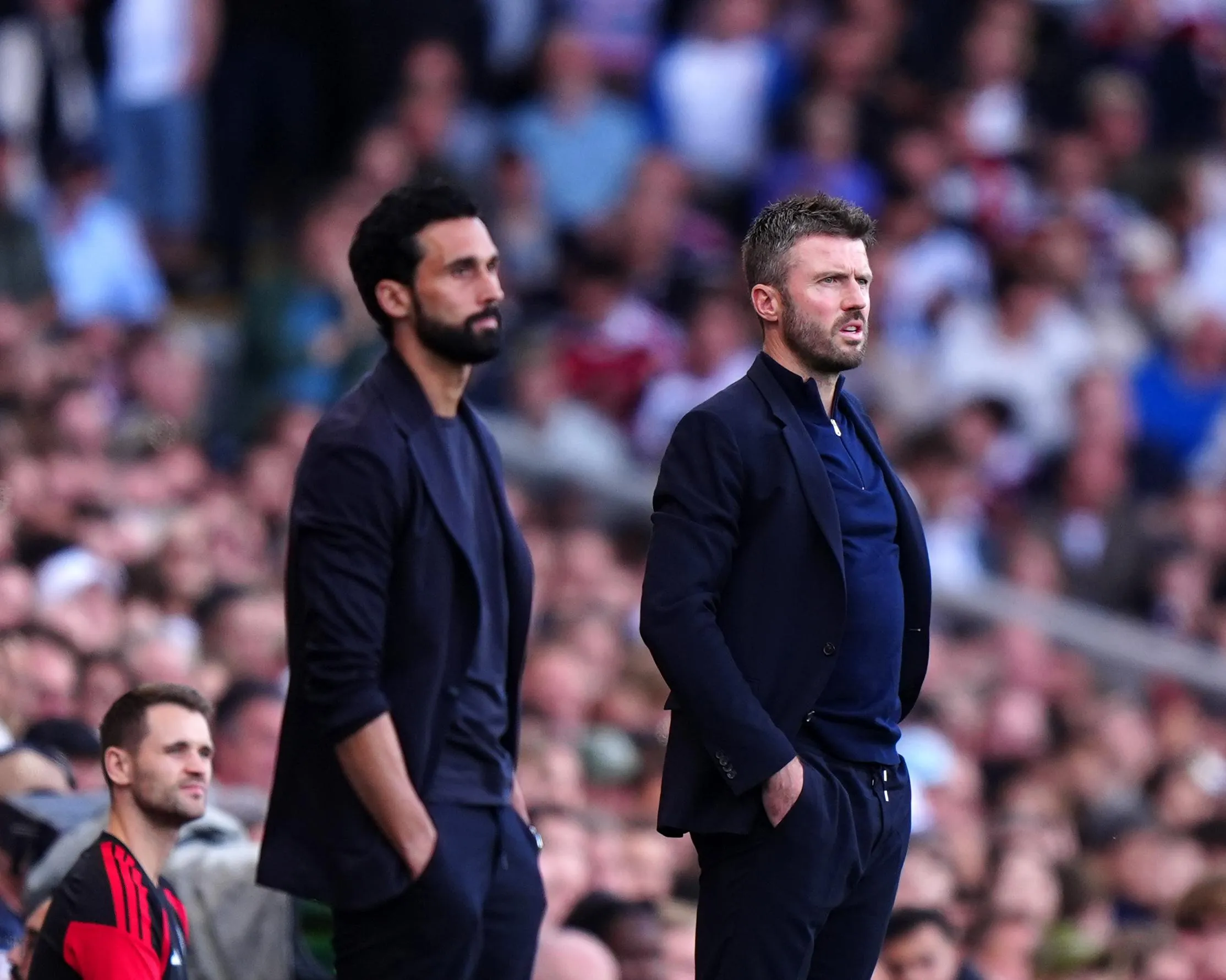 Fulham manager Alvaro Arbeloa and Manchester United manager Michael Carrick watch on from the touchline.
