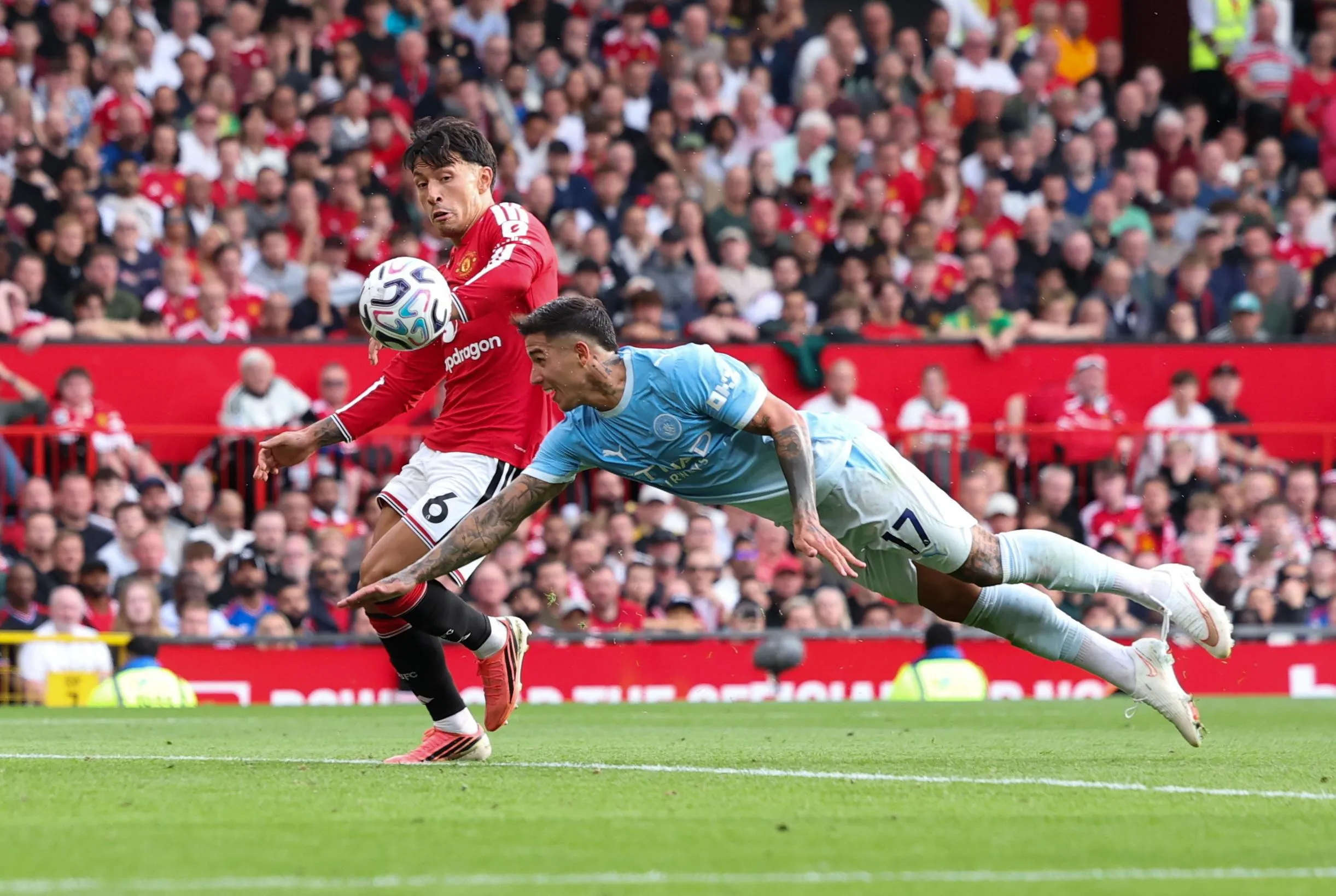 Enzo Fernandez of Manchester City (R) dives for the ball immediately before Erling Haaland (not pictured) scores the 0-1 goal during the English Premier League match between Manchester United and Manchester City, in Manchester, Britain, 13 September 2026.