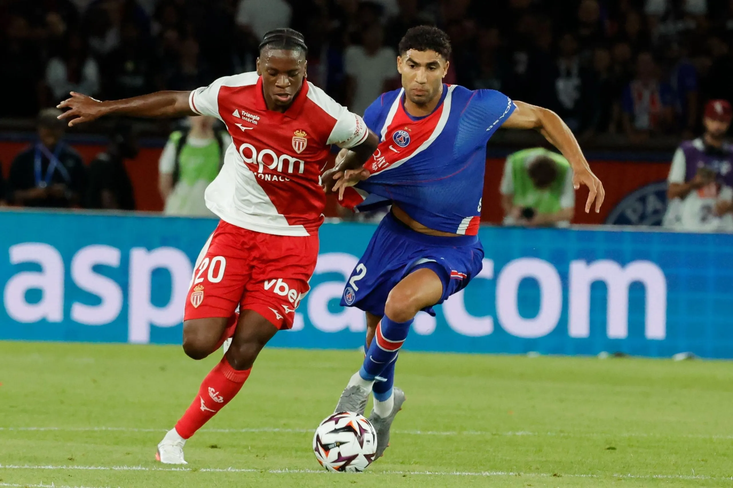 Achraf Hakimi of Paris Saint-Germain tussles for possession with Flavio Nazinho of Monaco.