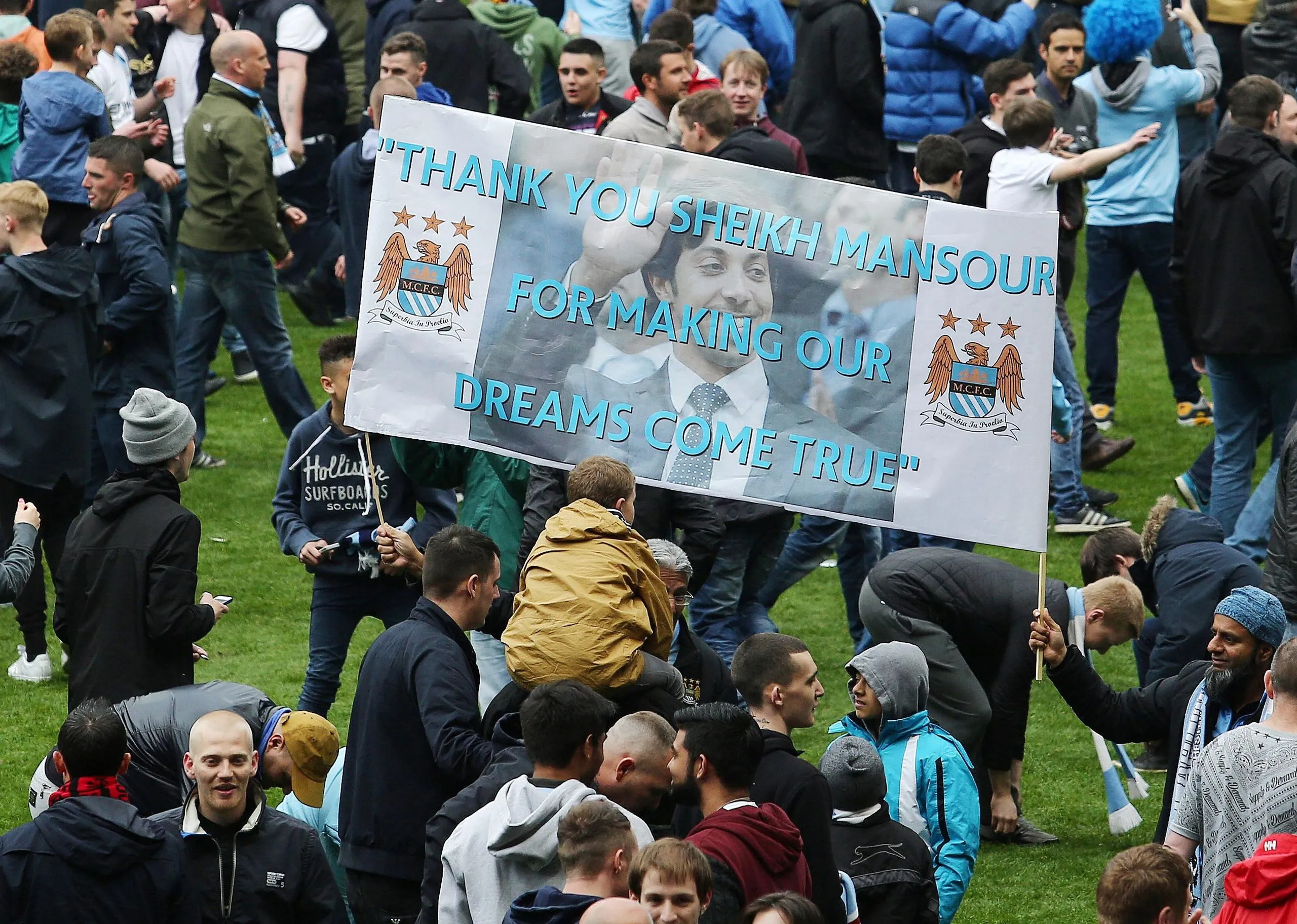 Manchester City fans display a banner on the pitch with an image of Sheikh Mansour and the words: 'Thank you Sheikh Mansour for making our dreams come true'
