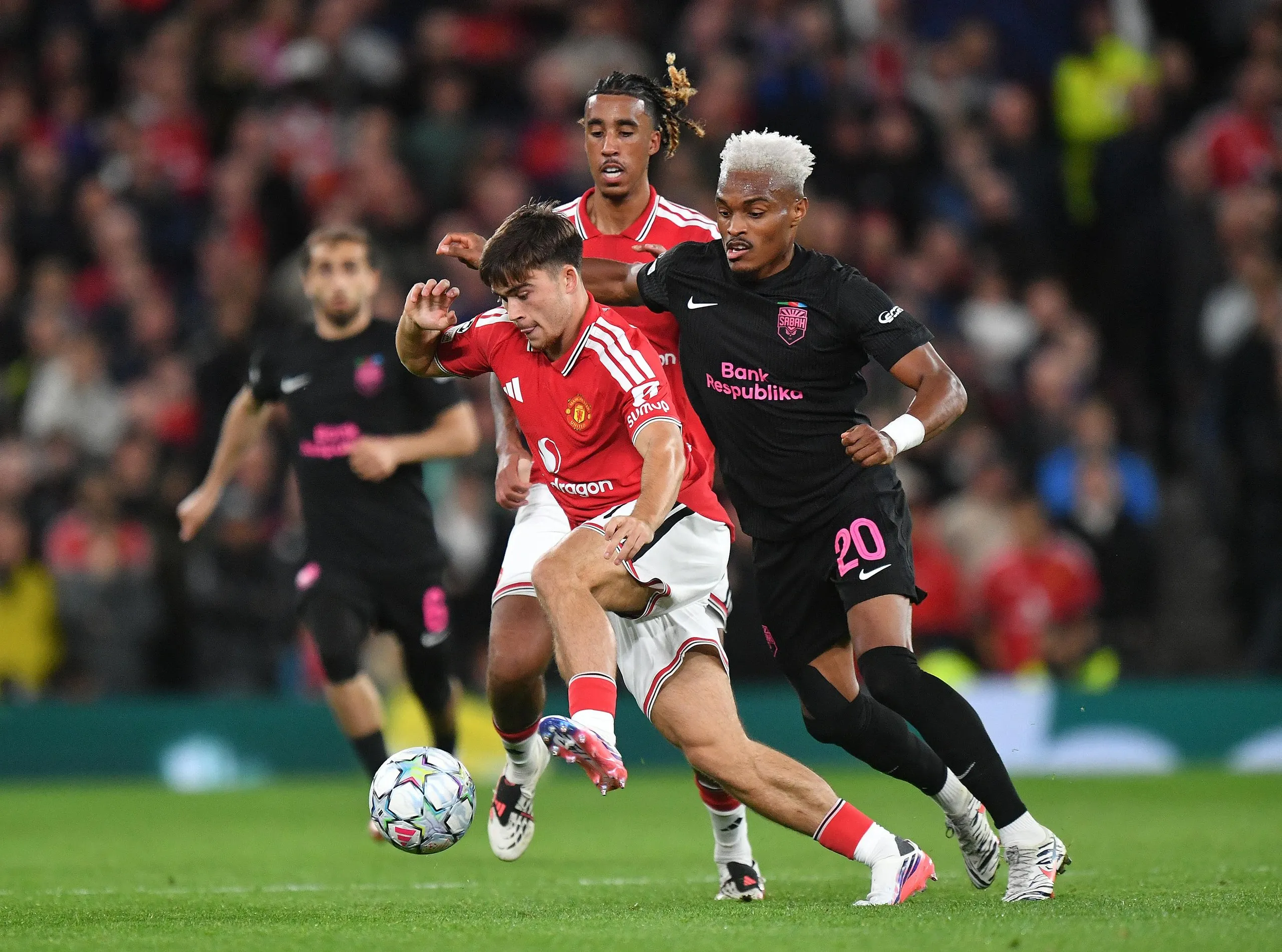 Harry Amass battles with Joy-Lance Mickels during the Champions League match between Manchester United and Sabah.