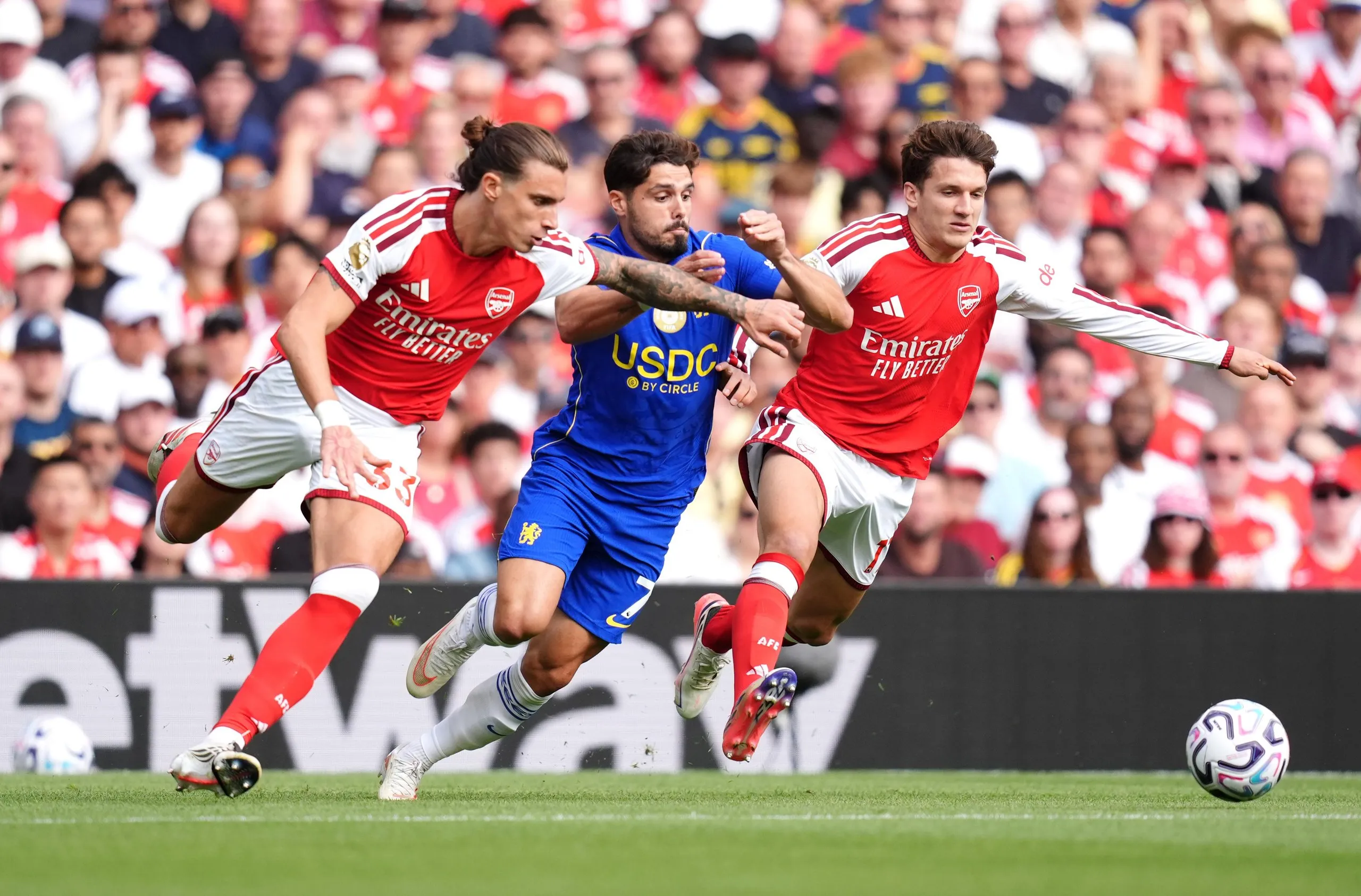 Arsenal’s Riccardo Calafiori (left) and Christos Tzolis team up to thwart Chelsea’s Pedro Neto