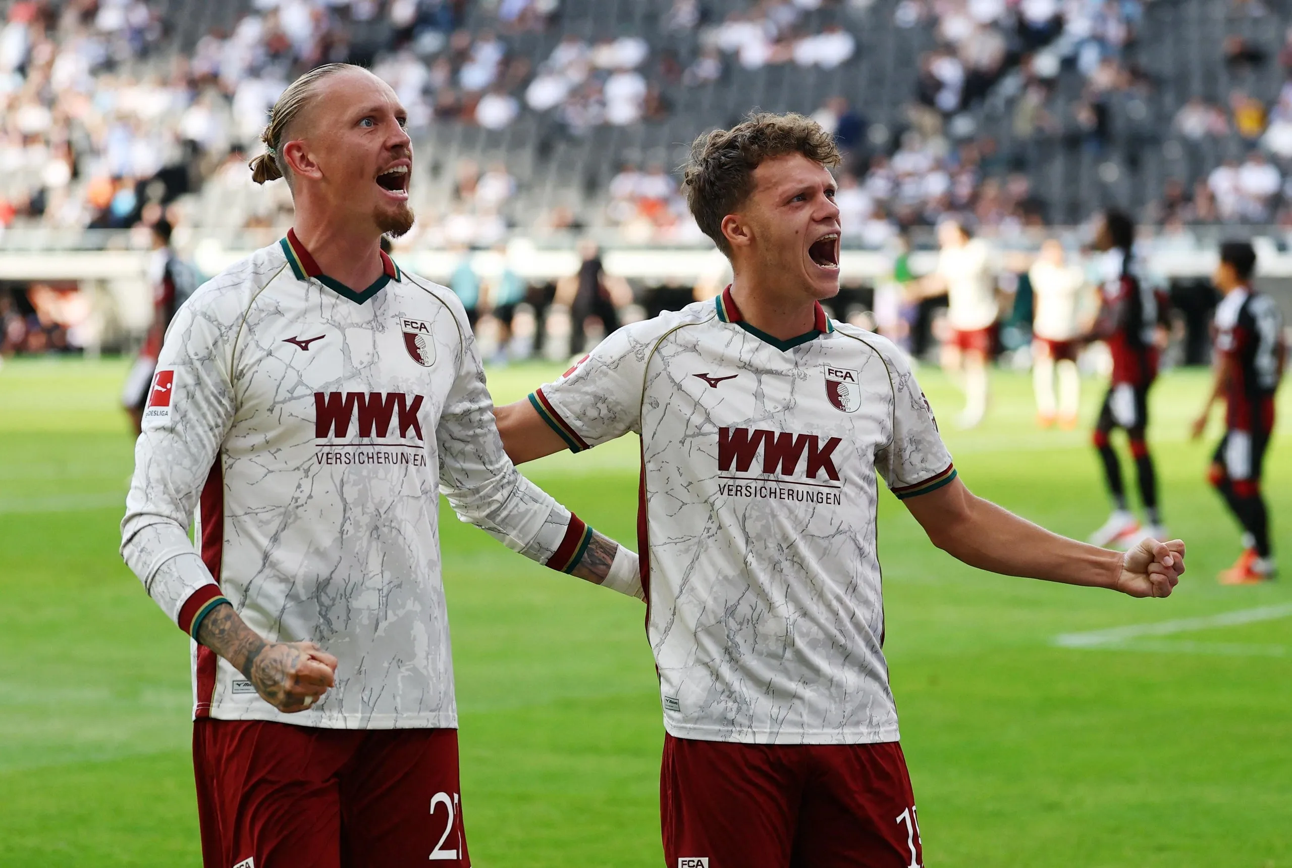 Augsburg’s Robin Fellhauer (right) celebrates his goal against Eintracht Frankfurt with team-mate Marius Wolf.