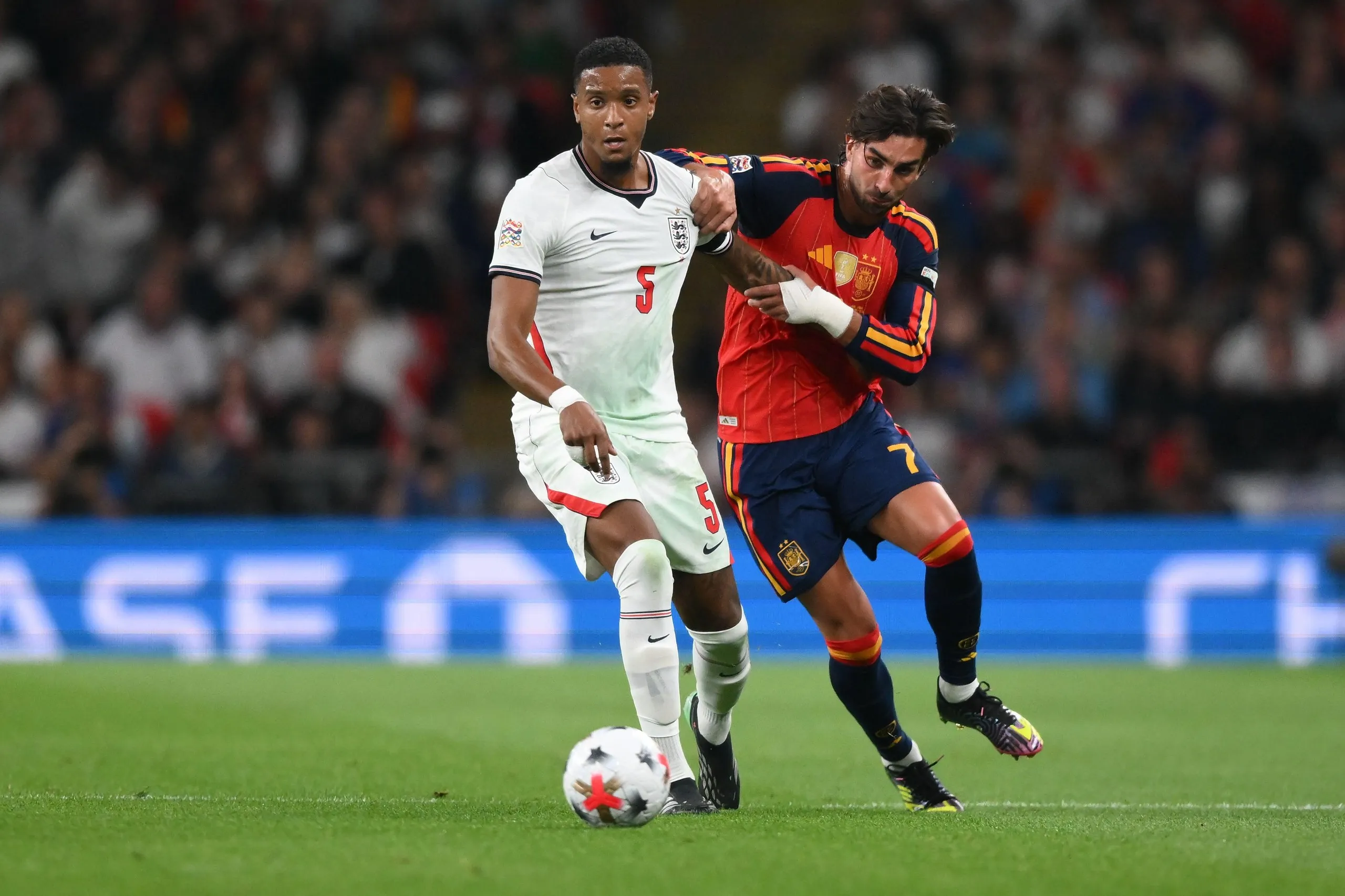 Ezri Konsa is challenged by Ferran Torres at Wembley