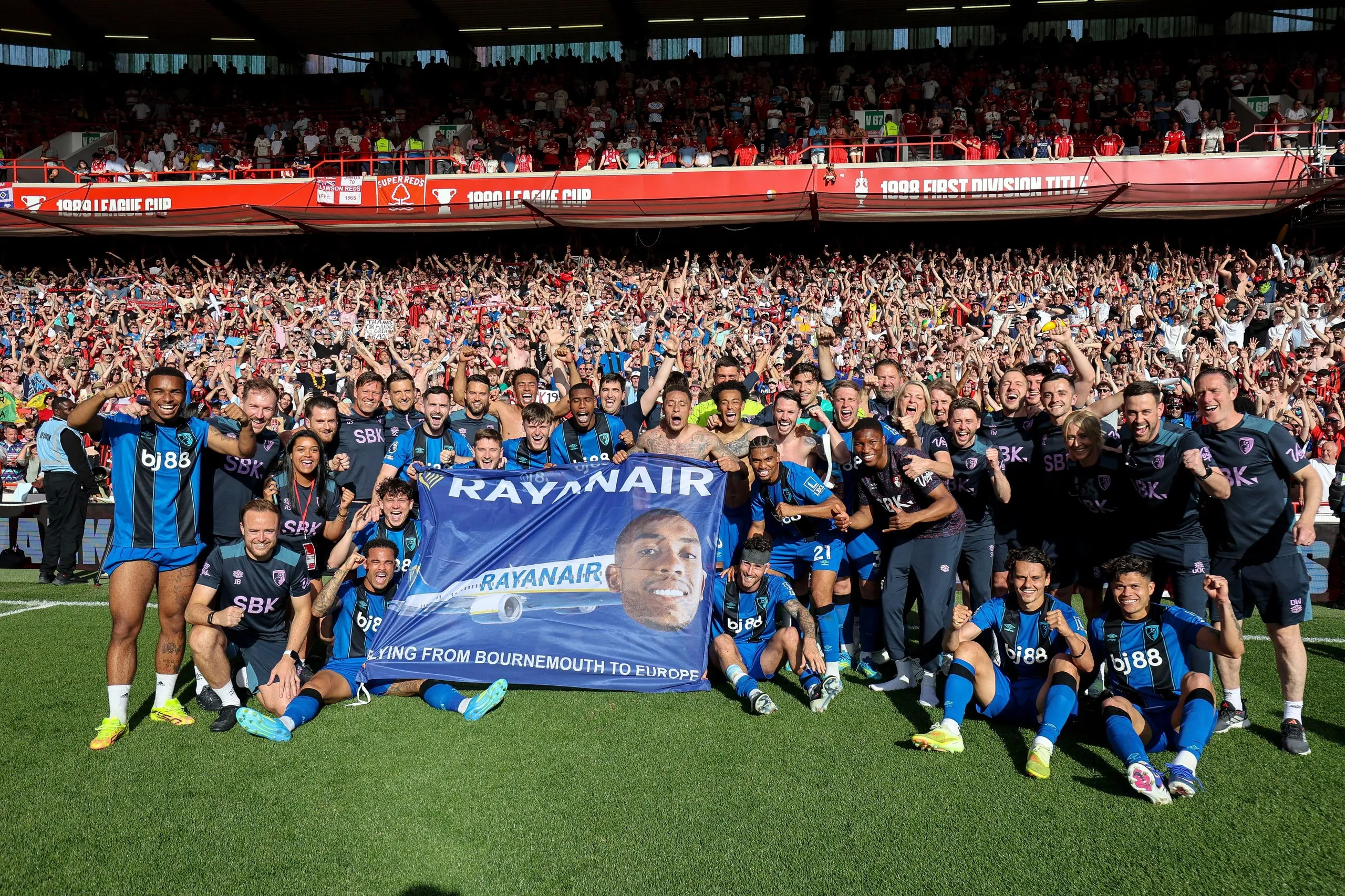 Bournemouth players sit around their ‘Rayanair’ banner after qualifying for the Europa League