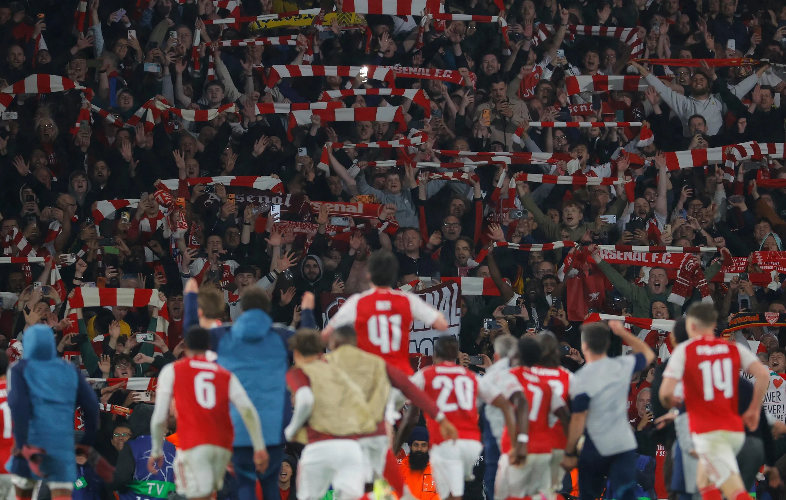 Arsenal players celebrate in front of their joyous fans during the Champions League 2025/26 semi-final second leg match against Atlético Madrid