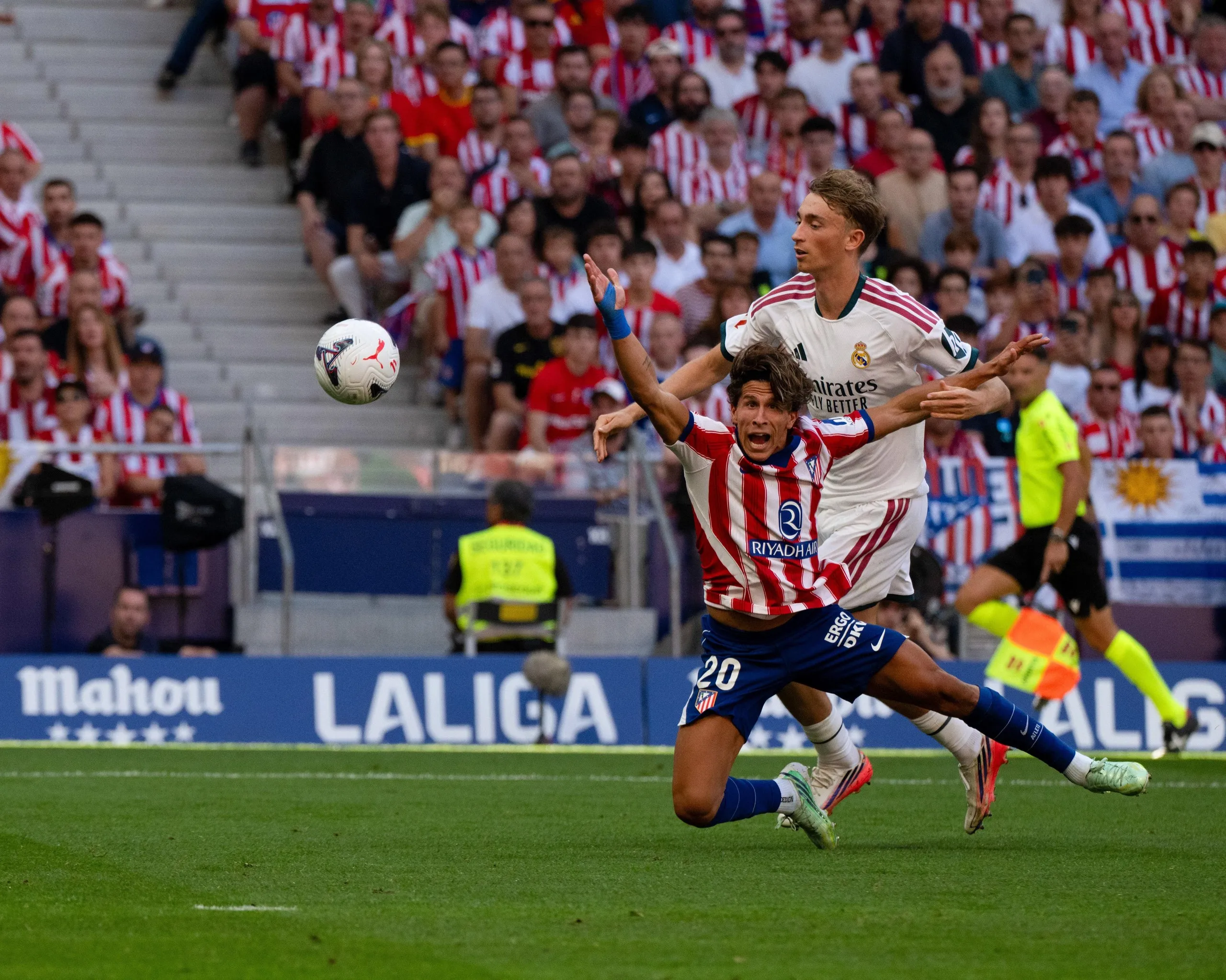 Dean Huijsen fouls Giuliano Simeone during the Madrid derby