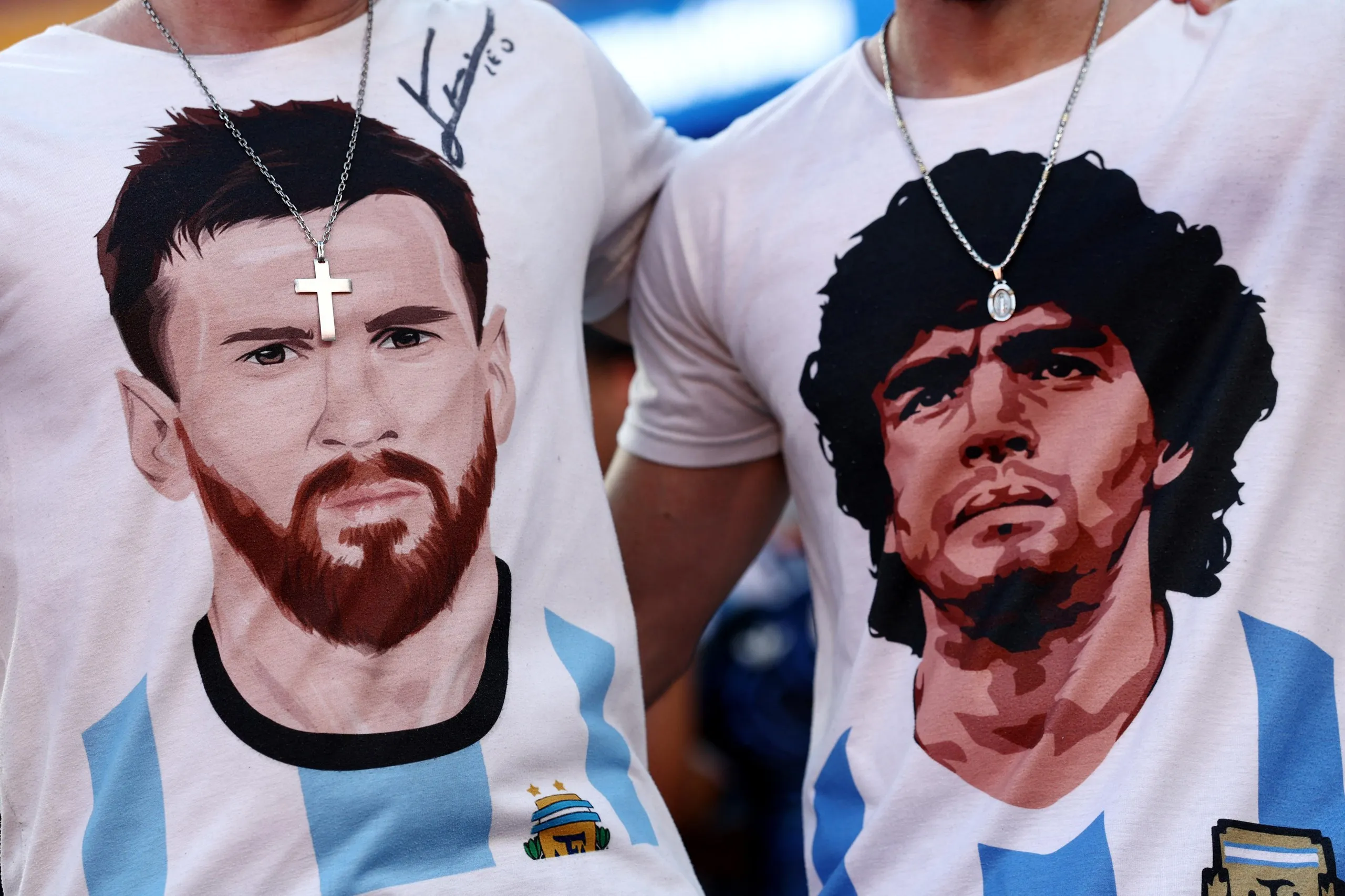 Argentina fans wearing T-shirts depicting Lionel Messi and Diego Maradona