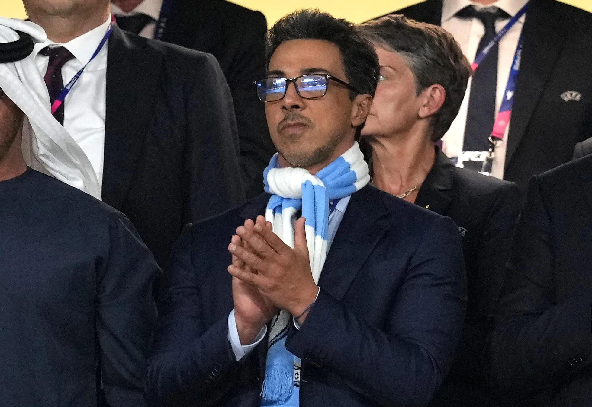 Sheikh Mansour wearing a Manchester City scarf and clapping