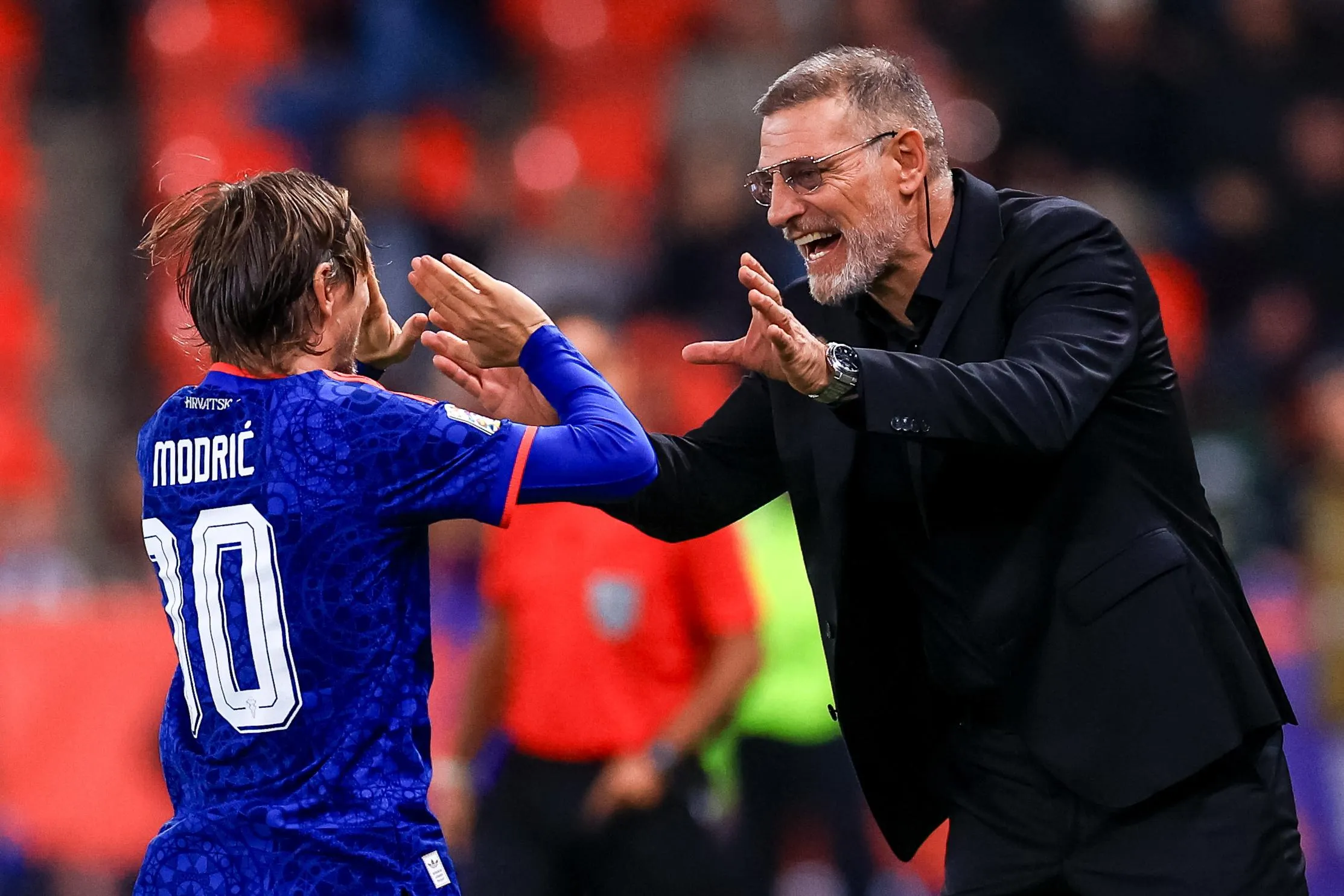 Luke Modric celebrates with Slaven Bilic.