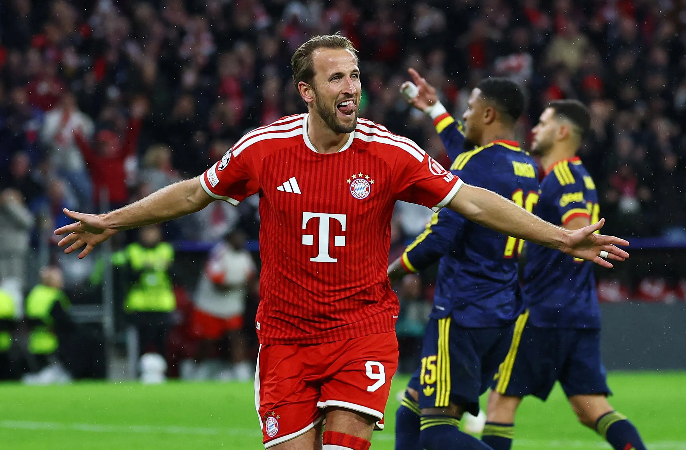 Harry Kane celebrates with arms outstretched after scoring for Bayern Munich
