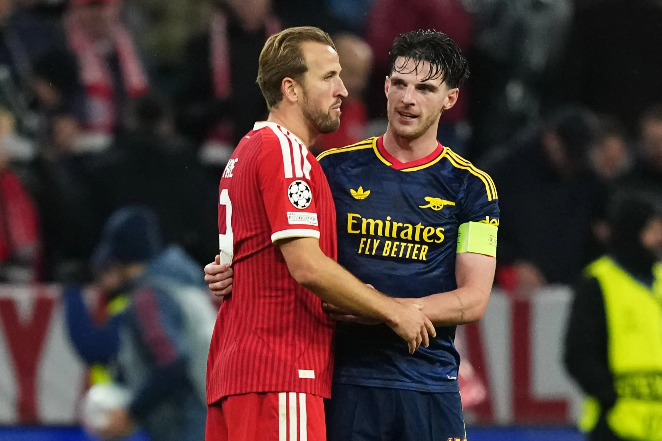 Bayern's Harry Kane (left) and Arsenal's Declan Rice hug.