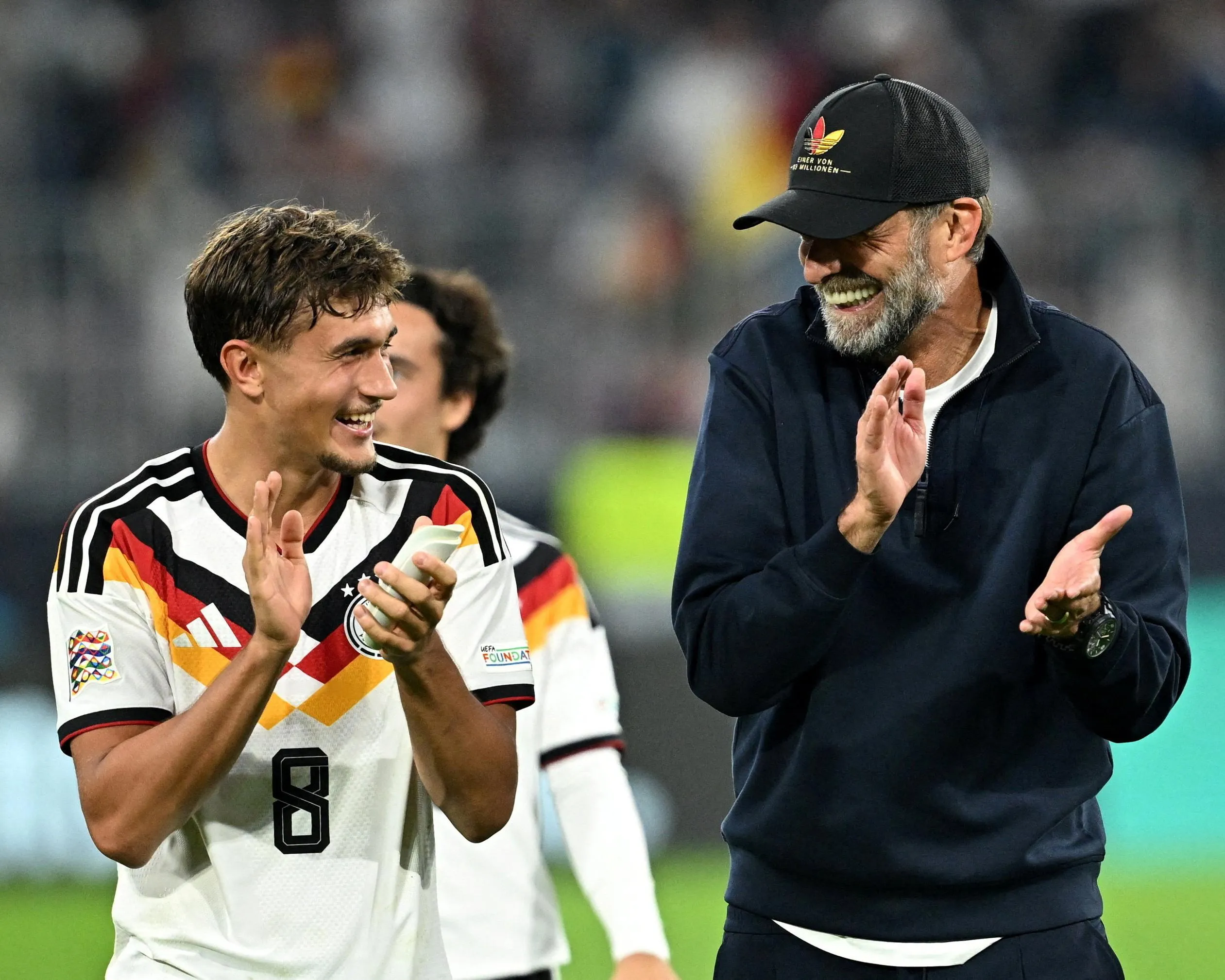 Jürgen Klopp (right) applauds fans alongside Tom Bischof, who scored his first international goal in the victory over Serbia