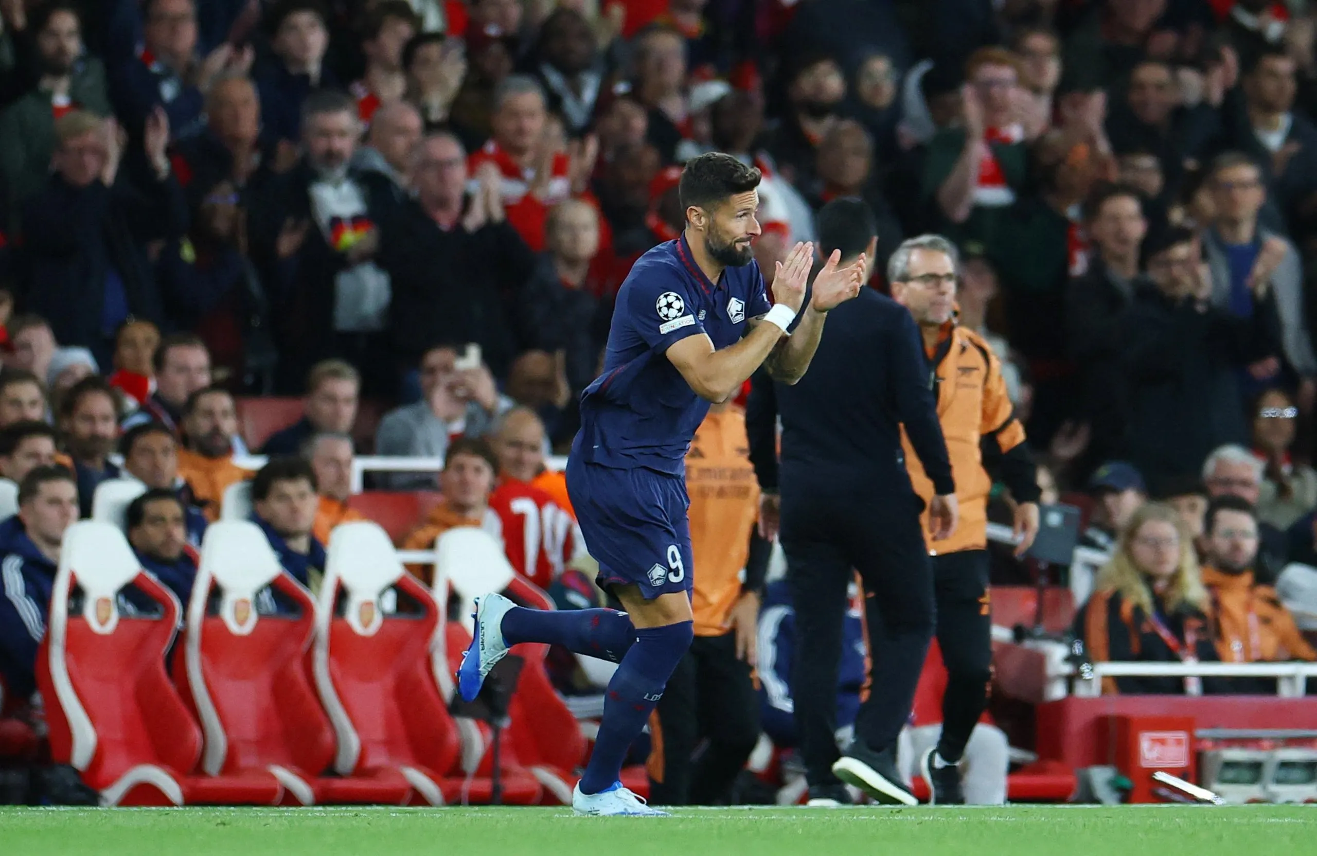 Lille's Olivier Giroud applauds the crowd as comes on as a substitute.