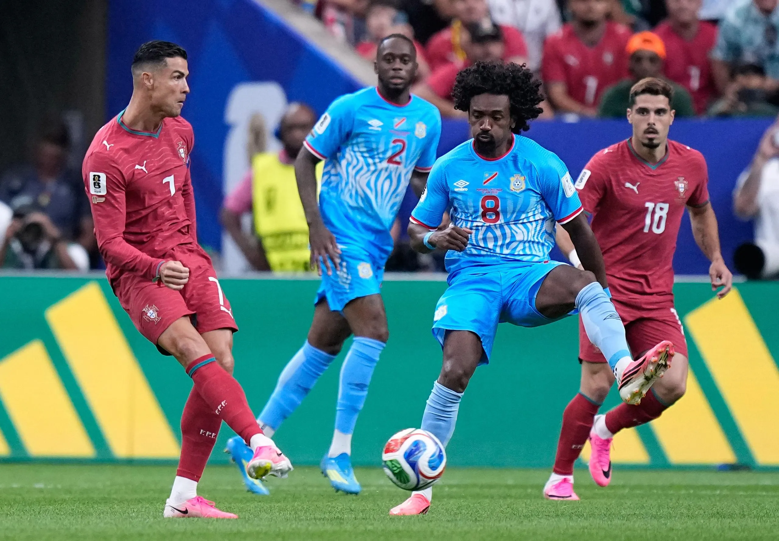 Portugal’s Cristiano Ronaldo, left, passes the ball in front of Congo’s Samuel Moutoussamy during the World Cup Group K match between Portugal and Congo