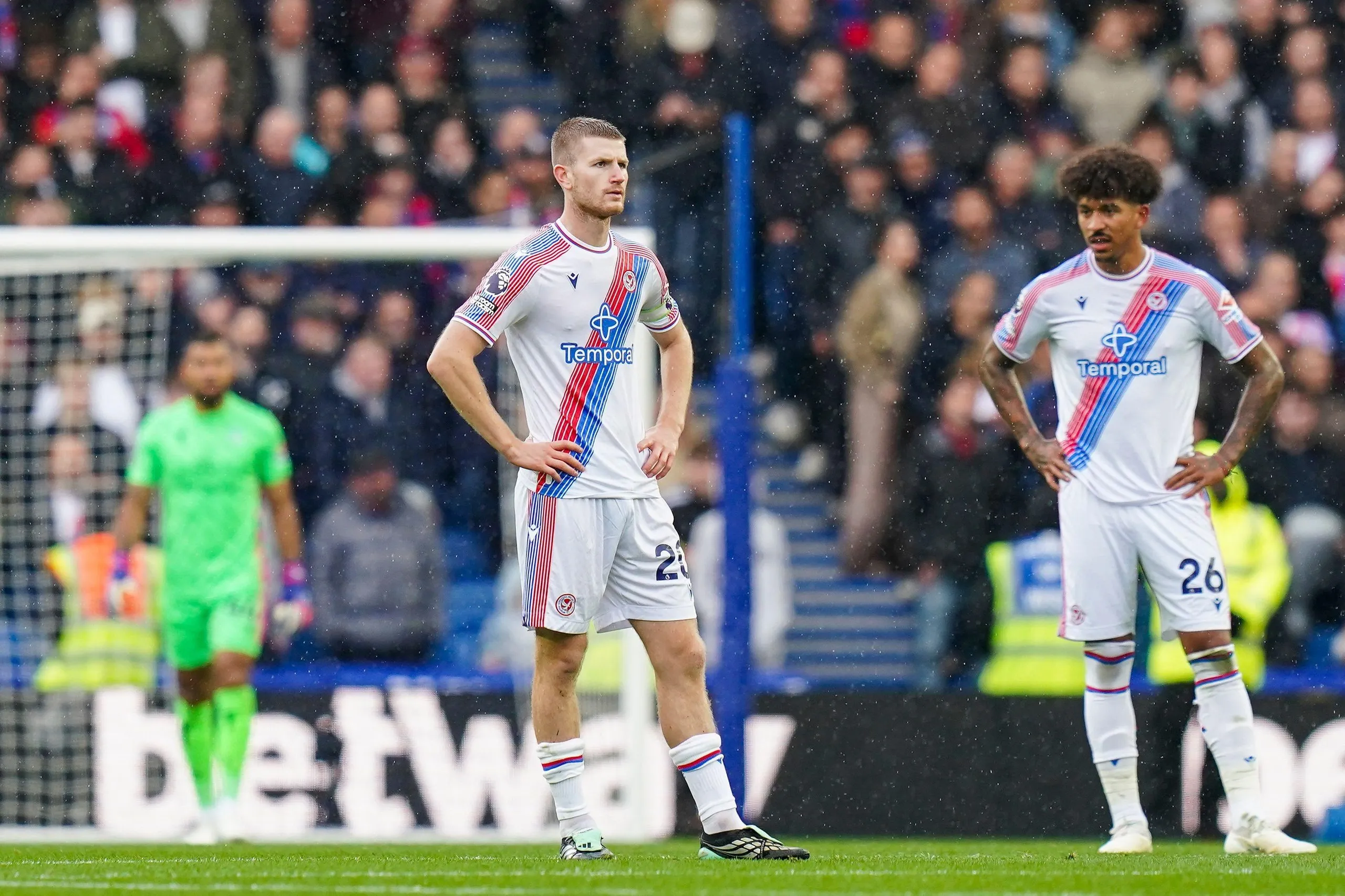 Crystal Palace's Adam Wharton and teammate stand dejected after conceding a goal