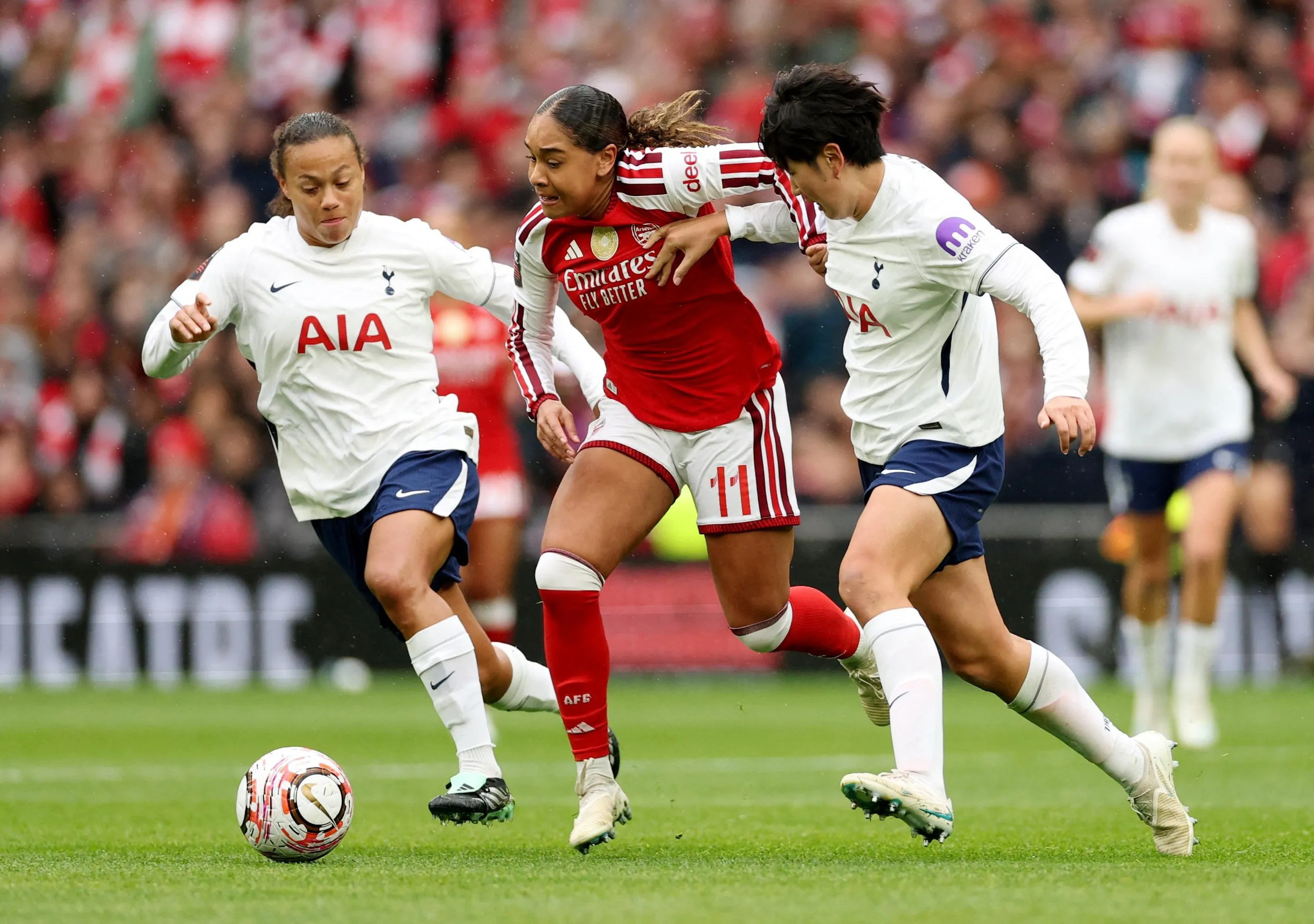 Arsenal's Olivia Smith battles with Tottenham