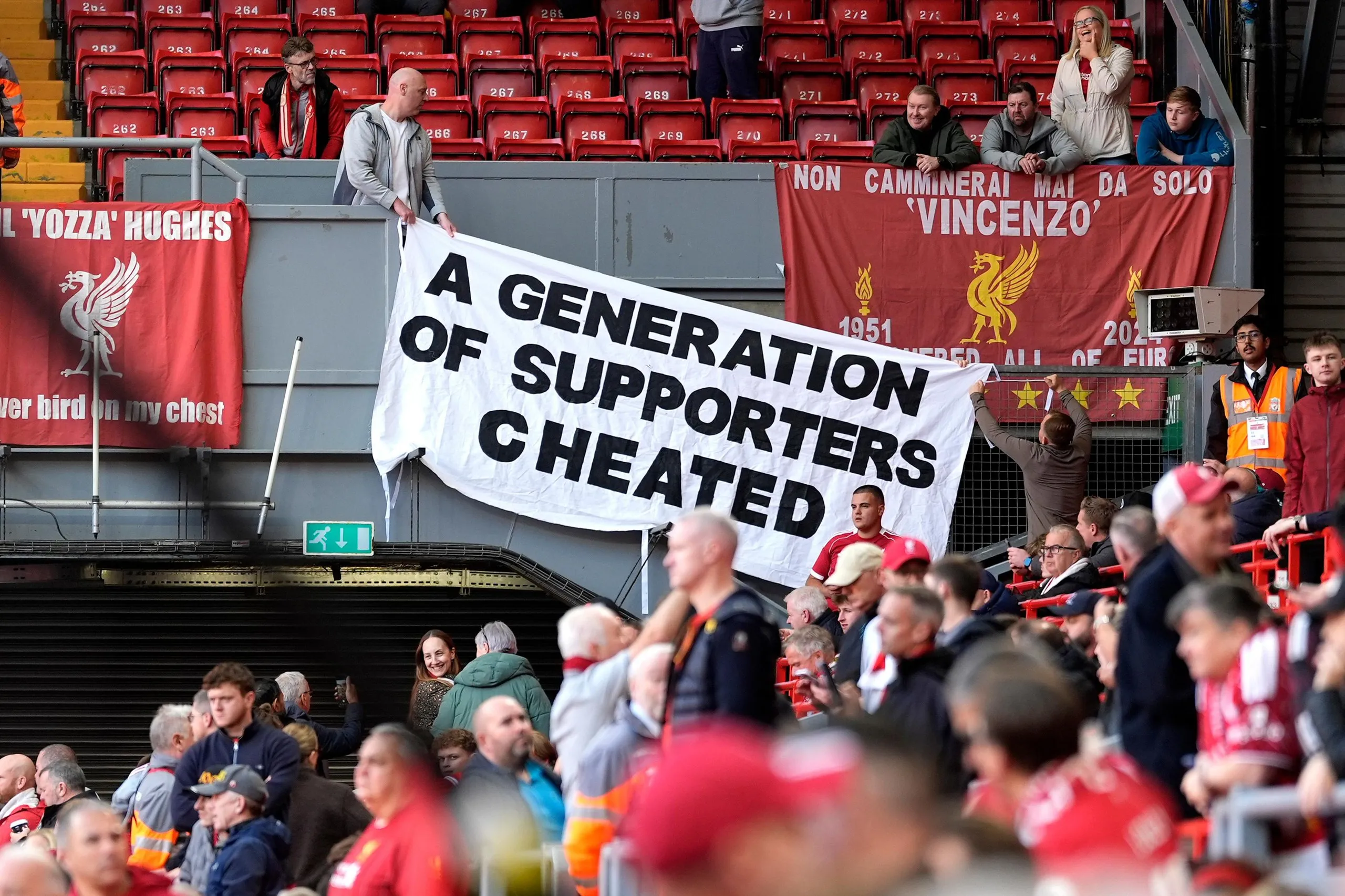 Liverpool supporters with a banner reading 'A generation of supporters cheated'