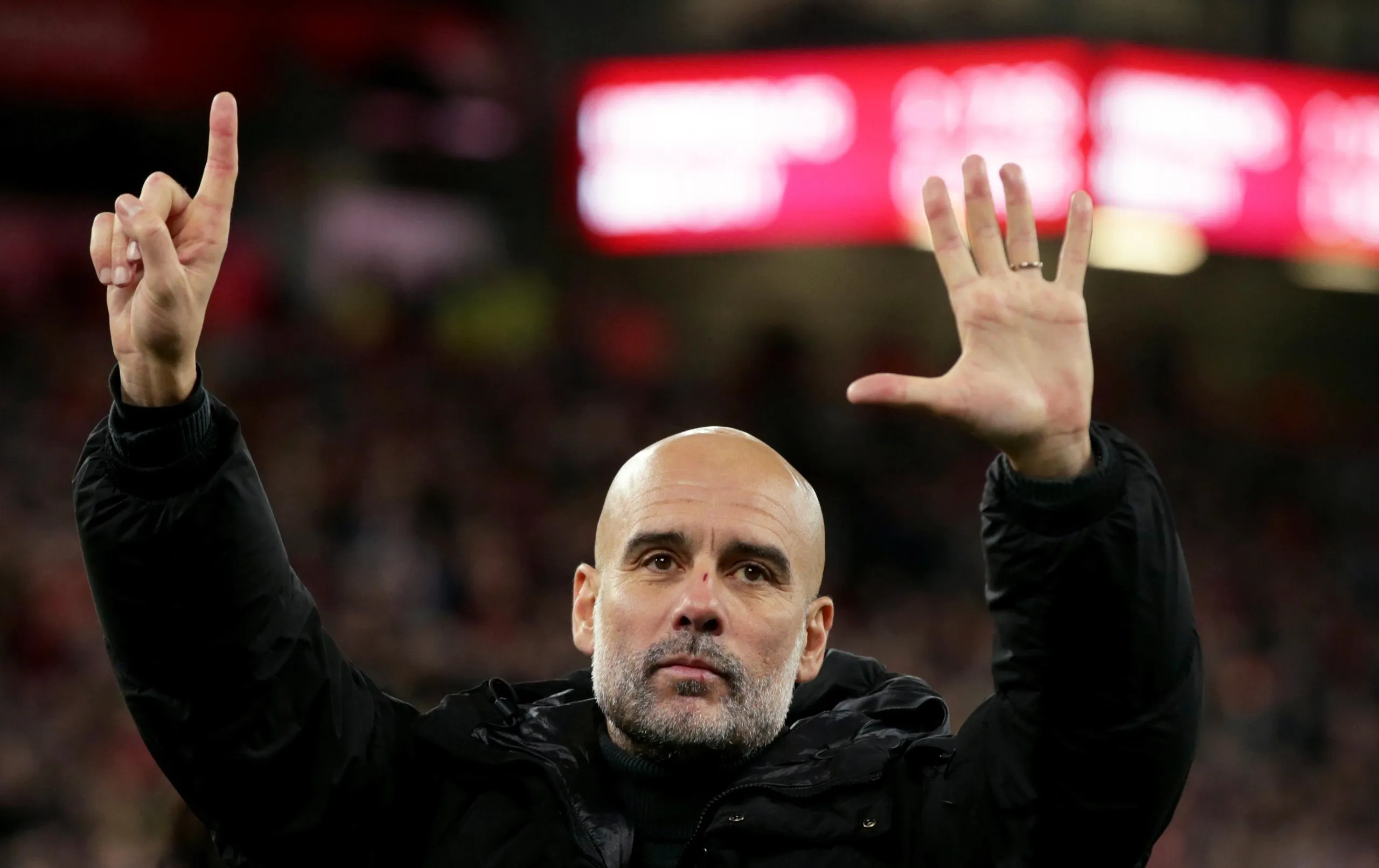 Manchester City’s head coach Pep Guardiola puts up six fingers to remind the jeering fans of his six Premier League titles at Liverpool in December 2024