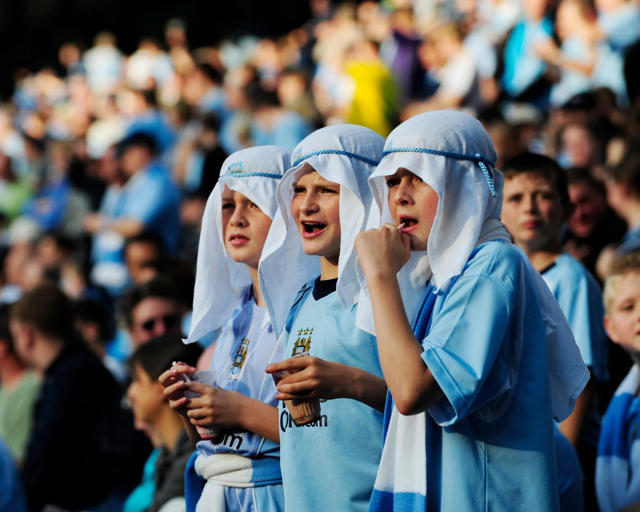 Boys dressed in head-scarves before the first game after the club was bought by the Abu Dhabi United group.