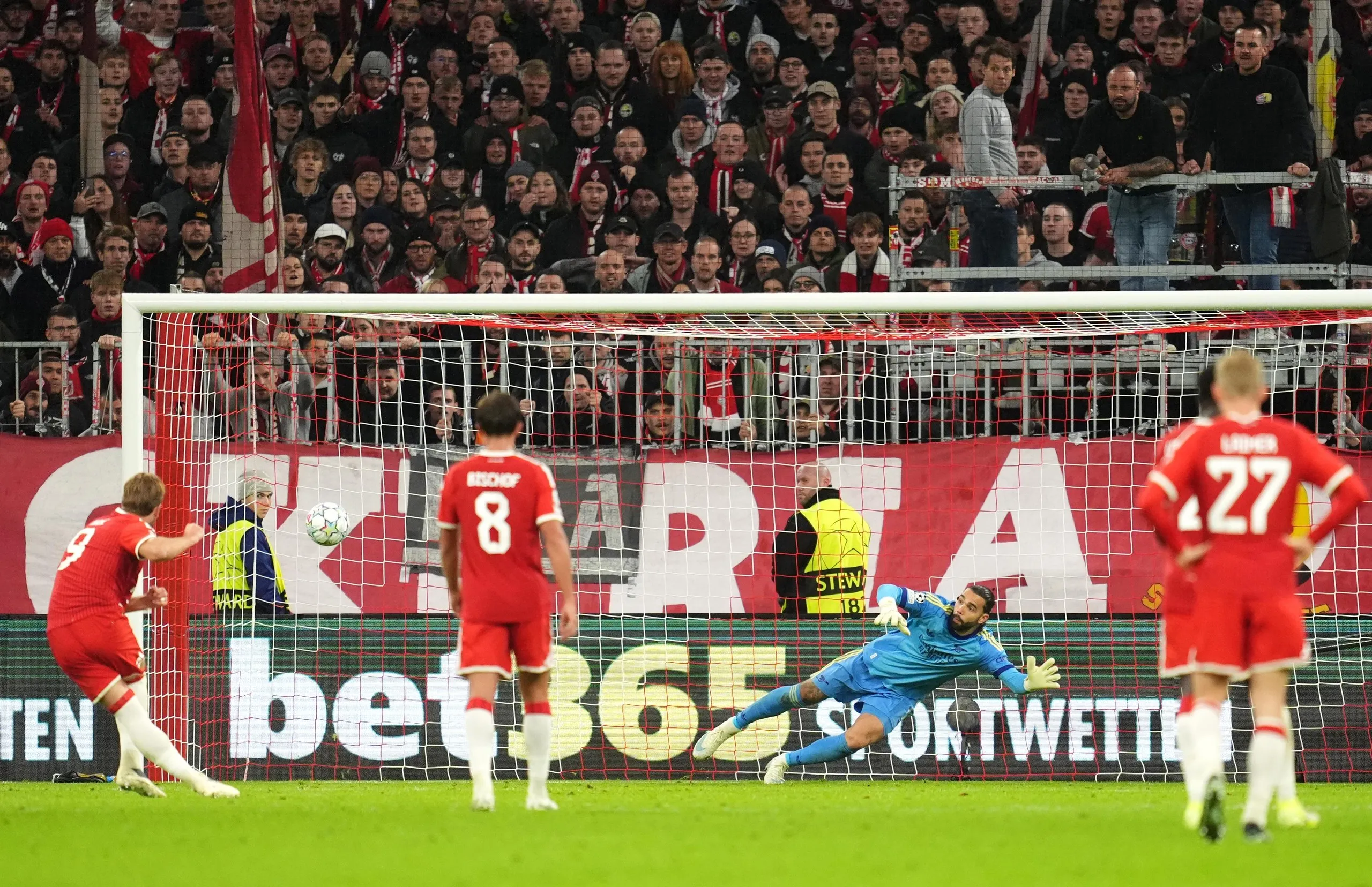 Harry Kane scores a penalty past diving goalkeeper David Raya during a Champions League match