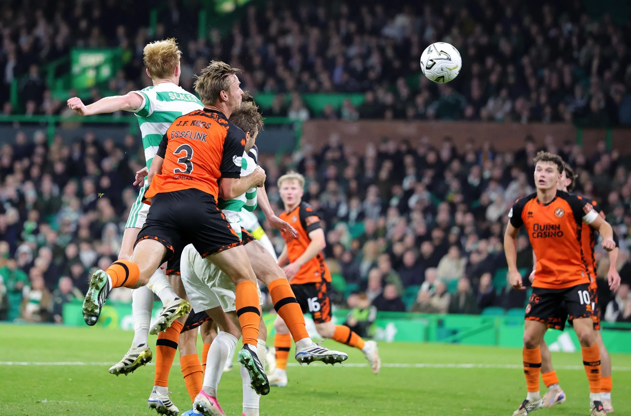 Celtic's Liam Scales jumps to make it 2-2 against Dundee United