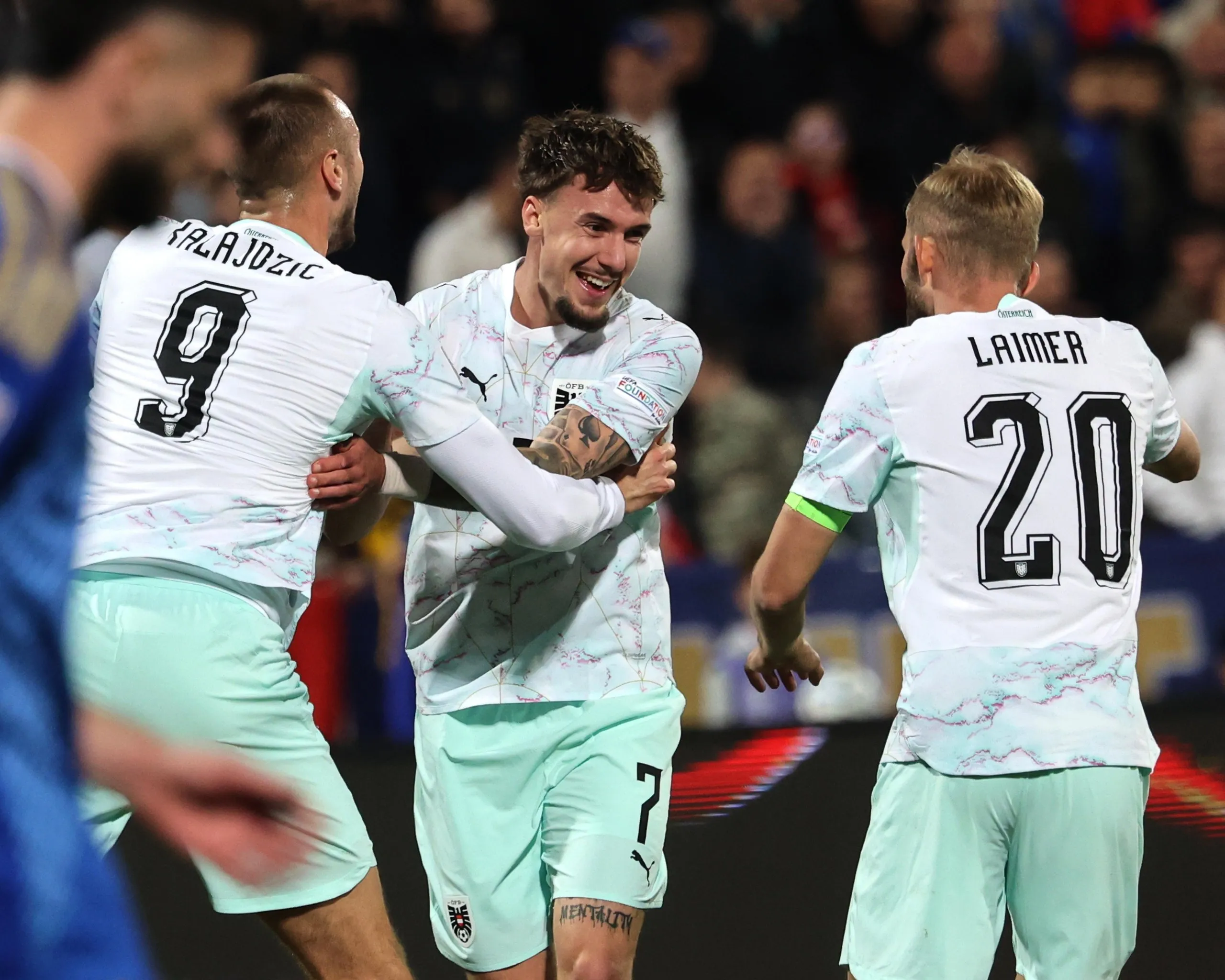 Christoph Lang (centre) celebrates after scoring for Austria against Kosovo earlier this month in just his second international appearance.