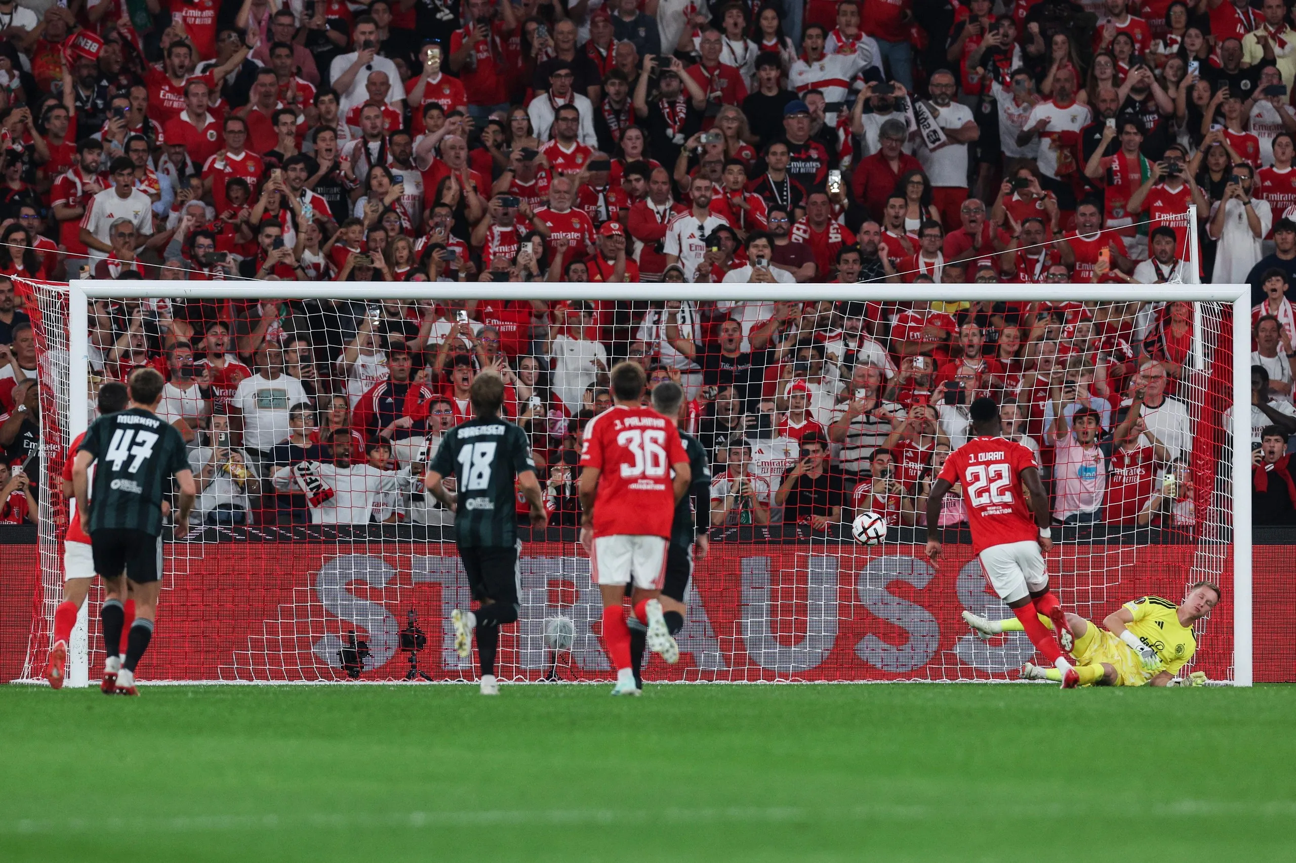 Benfica`s Jhon Duran (second right) scores a penalty against Celtic.